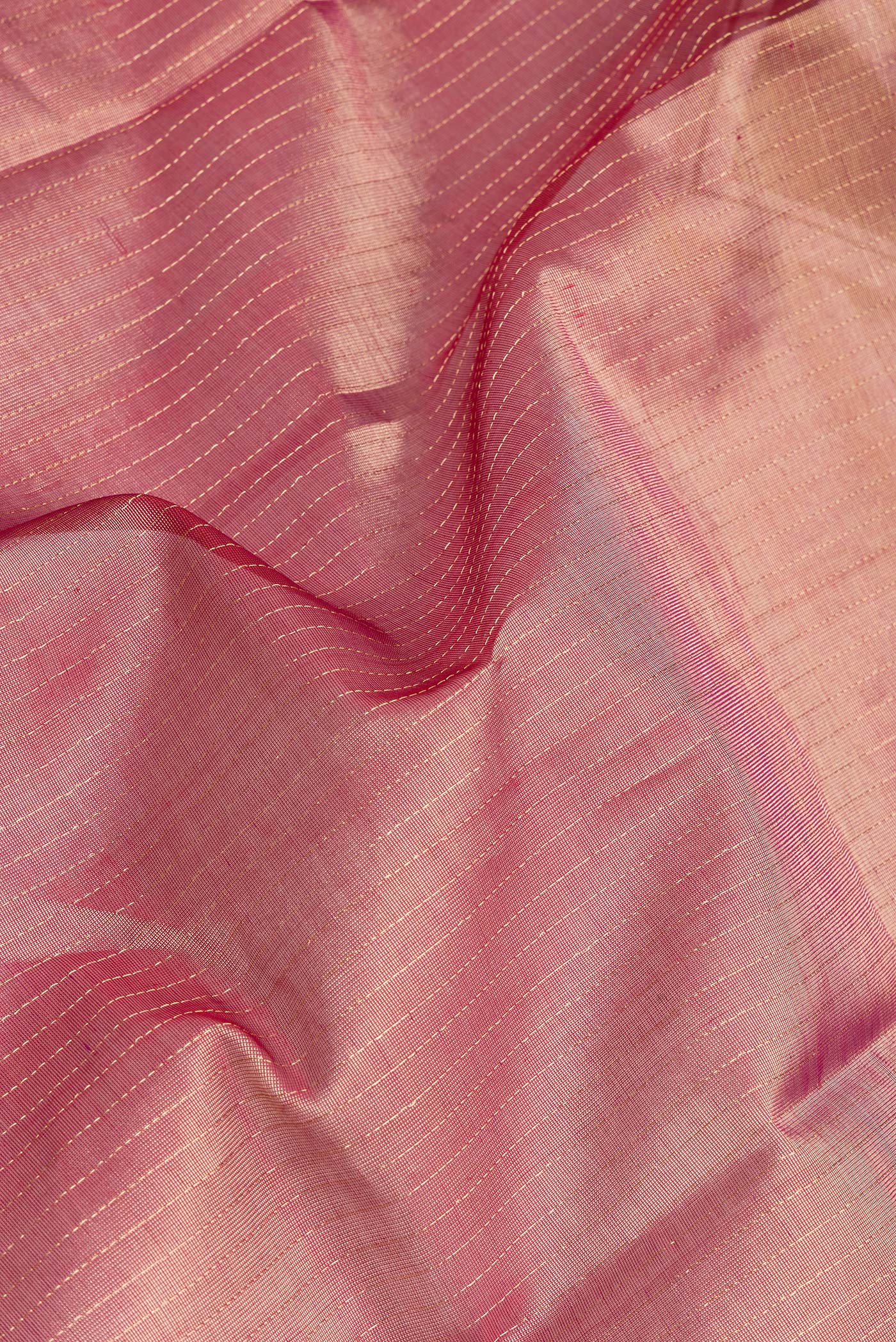 Close up of Maroon Dual Tone Silk Cotton Saree with Stripes on the body and Zari And Thread Border.  displaying folds