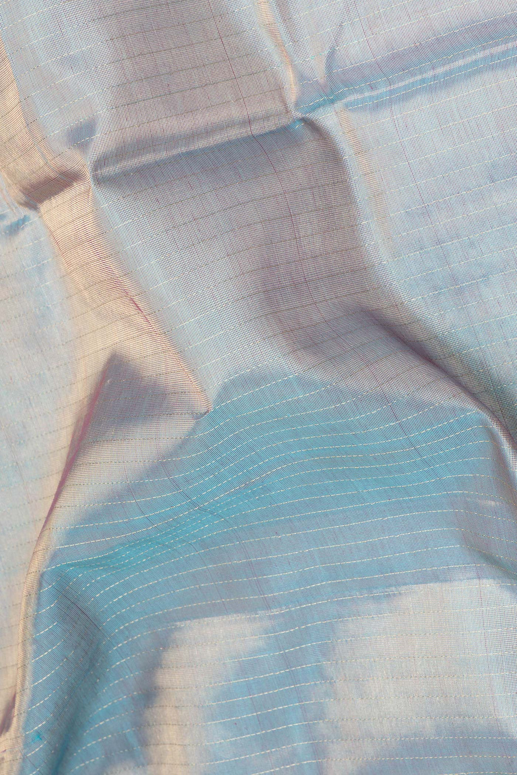 Close up of Peacock Blue Dual Tone Silk Cotton Saree with Checked design on the body and Zari And Thread Border.  displaying folds