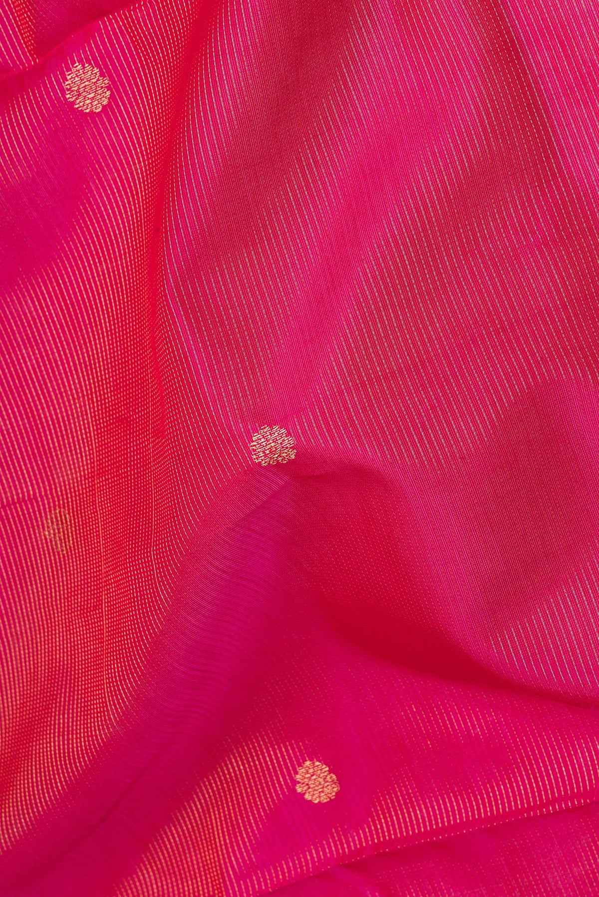 Close up of Dark Pink Silk Cotton Saree with Stripes on the body and Zari Border.  displaying folds