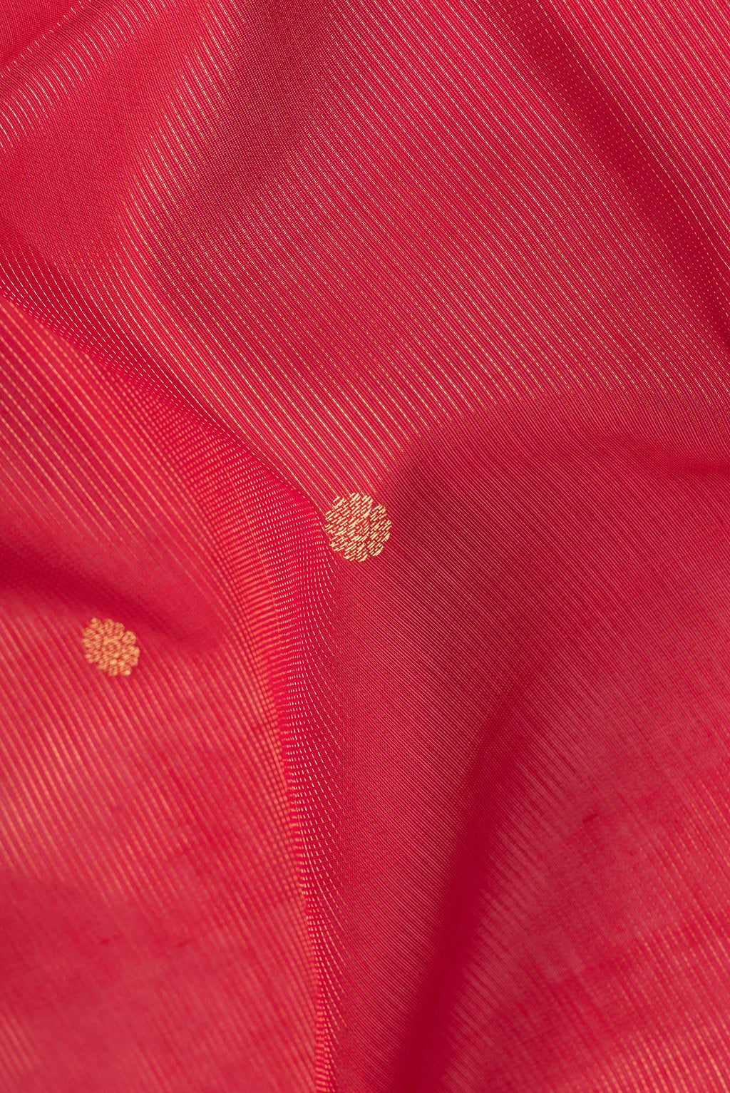 Close up of Red Silk Cotton Saree with Stripes on the body and Zari Border.  displaying folds