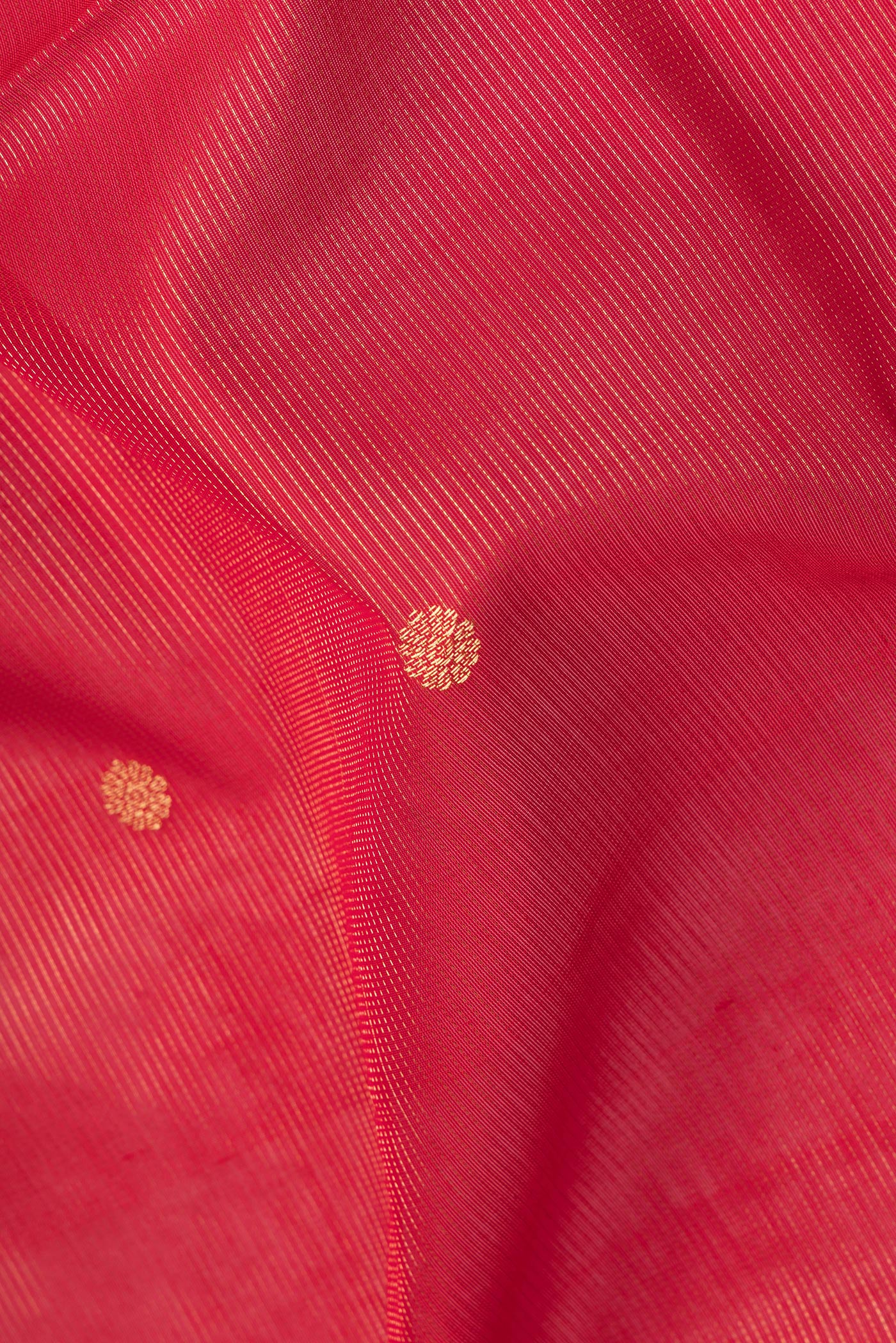 Close up of Red Silk Cotton Saree with Stripes on the body and Zari Border.  displaying folds