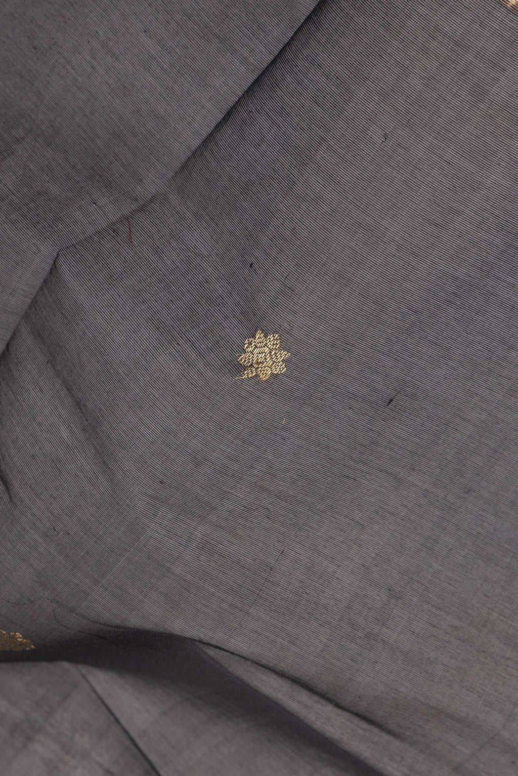 Close up of Black Silk Cotton Saree with Zari Butta on the body and Fancy Border.  displaying folds