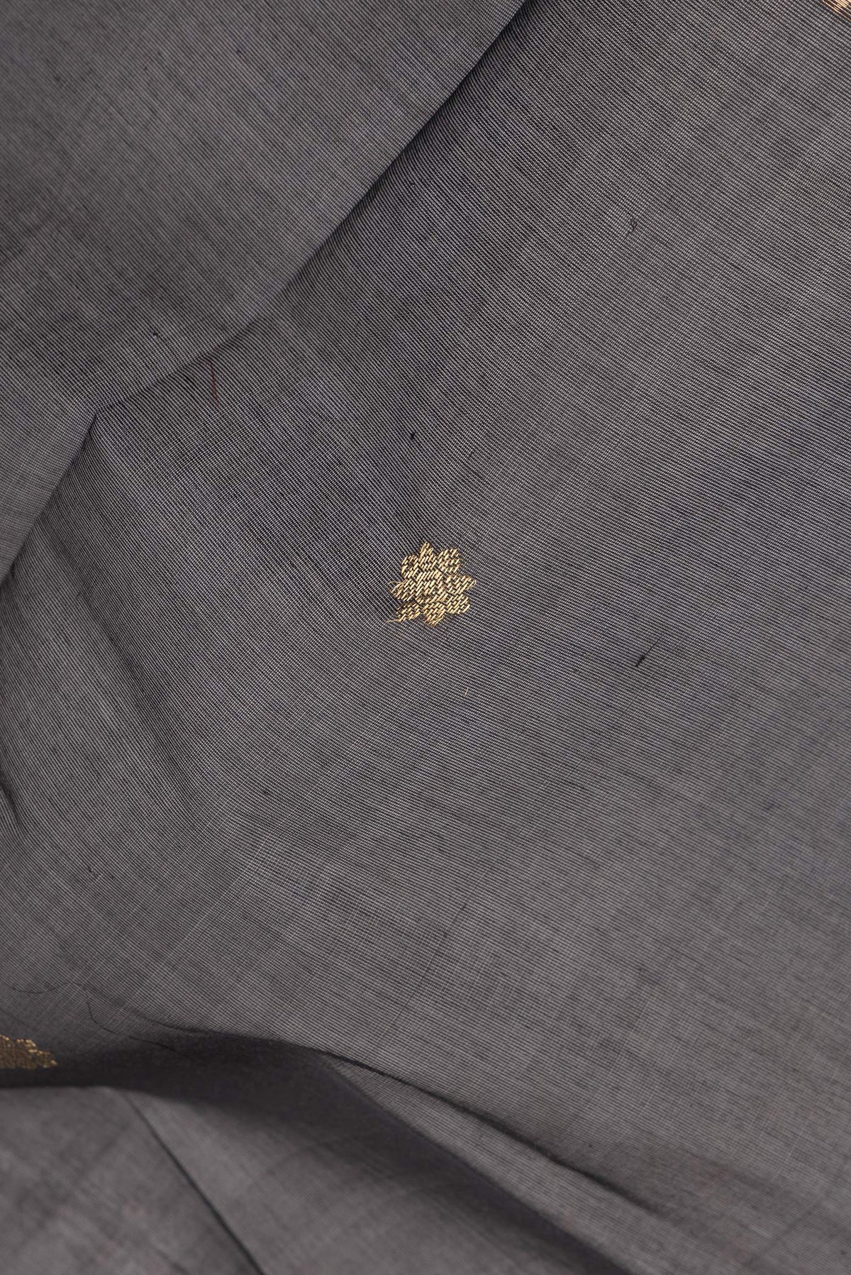 Close up of Black Silk Cotton Saree with Zari Butta on the body and Fancy Border.  displaying folds