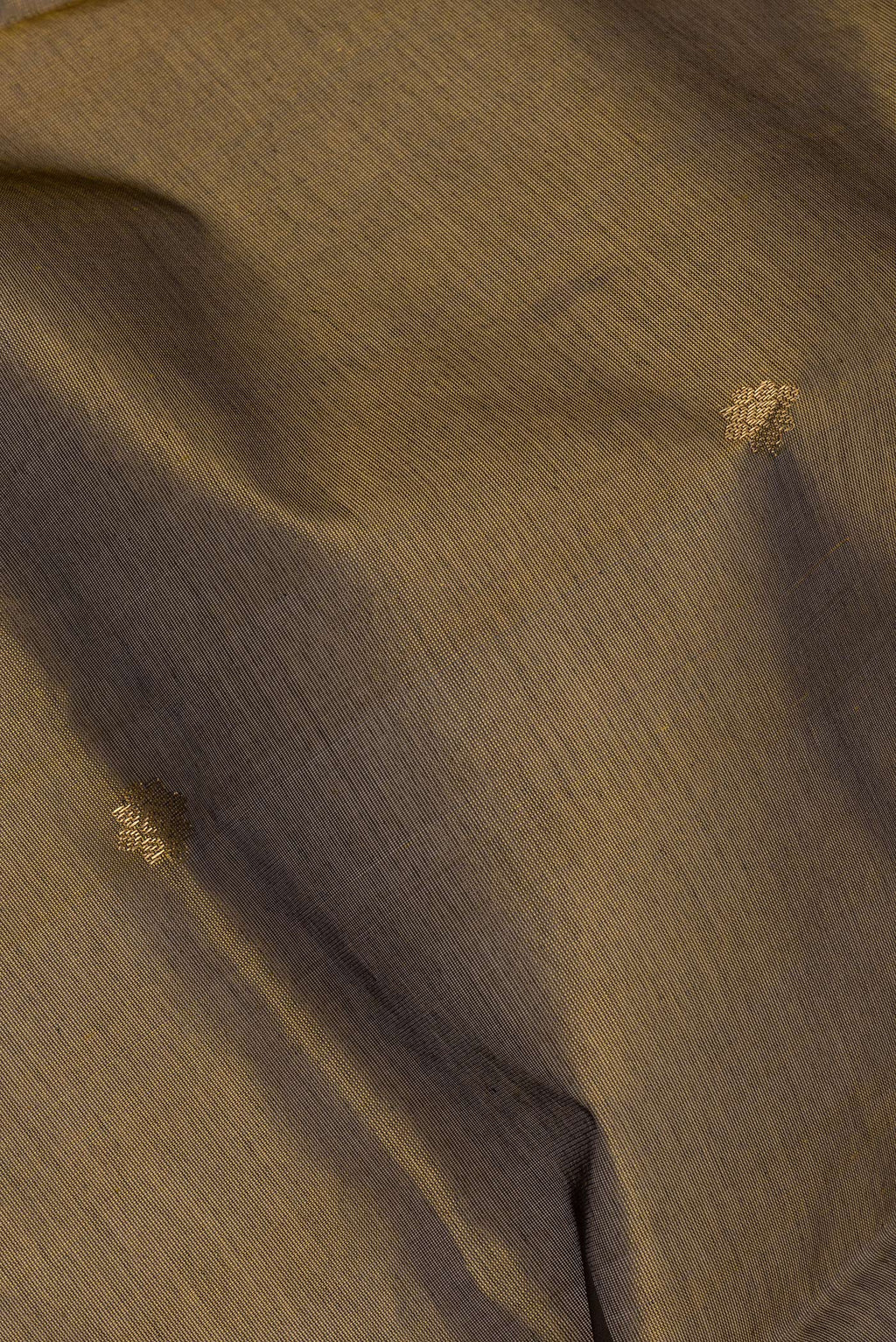 Close up of Mehandi Green Silk Cotton Saree with Zari Butta on the body and Zari Border.  displaying folds