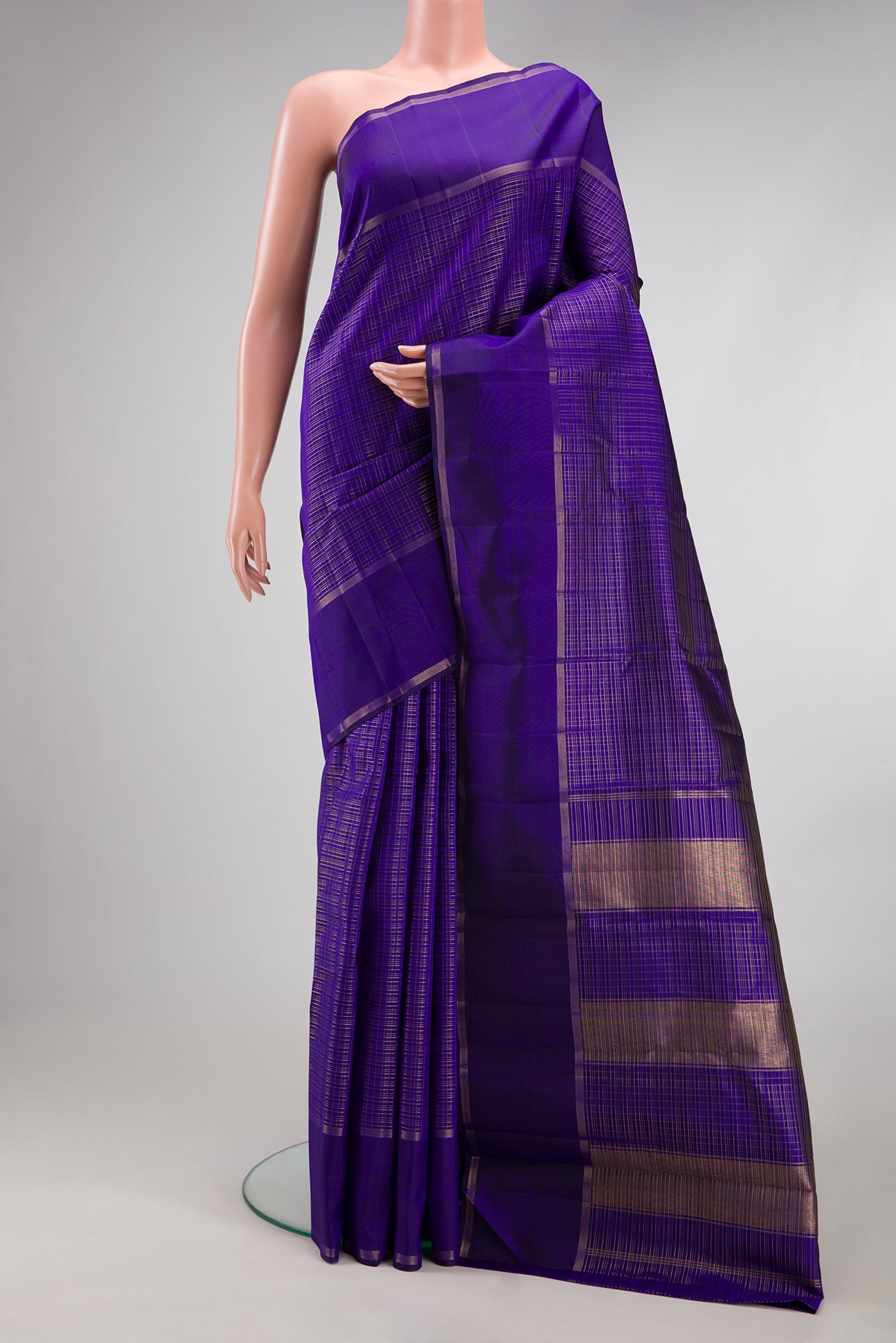 Royal Blue Kanchipuram Silk Saree with Checked design on the body and Zari Border.  displayed on a mannequin