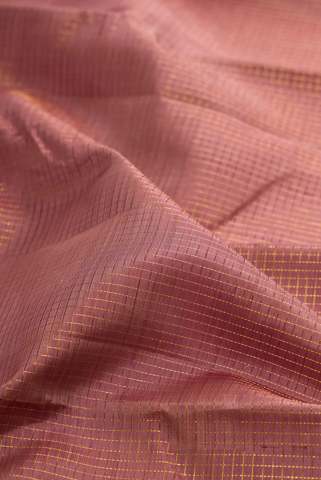 Close up of Mauve Kanjivaram Silk Saree with Checked design on the body and Plain Border.  displaying folds