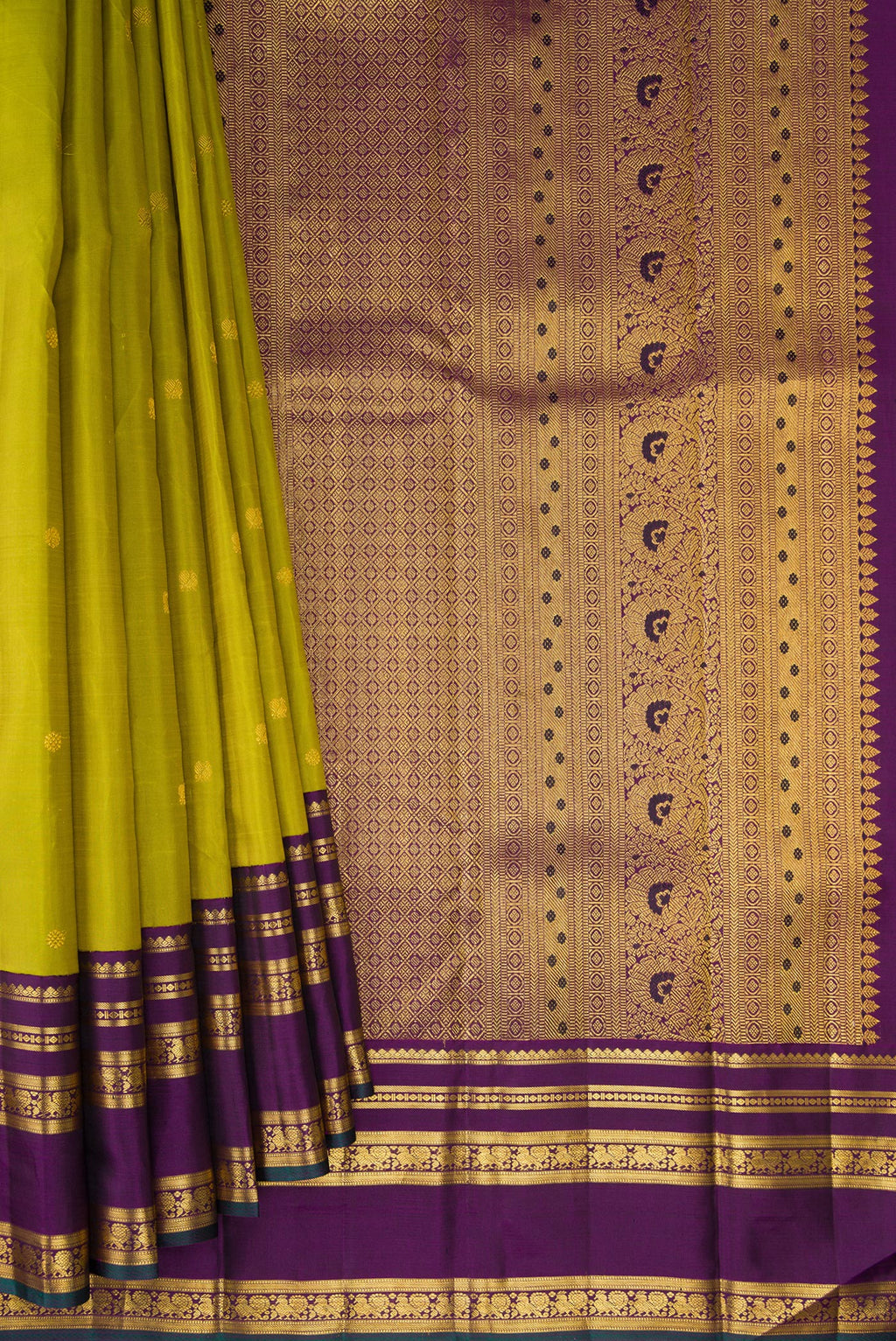 Pleats and pallu of Green Kanchipuram Silk Saree with Zari Butta on the body and Zari Border. 