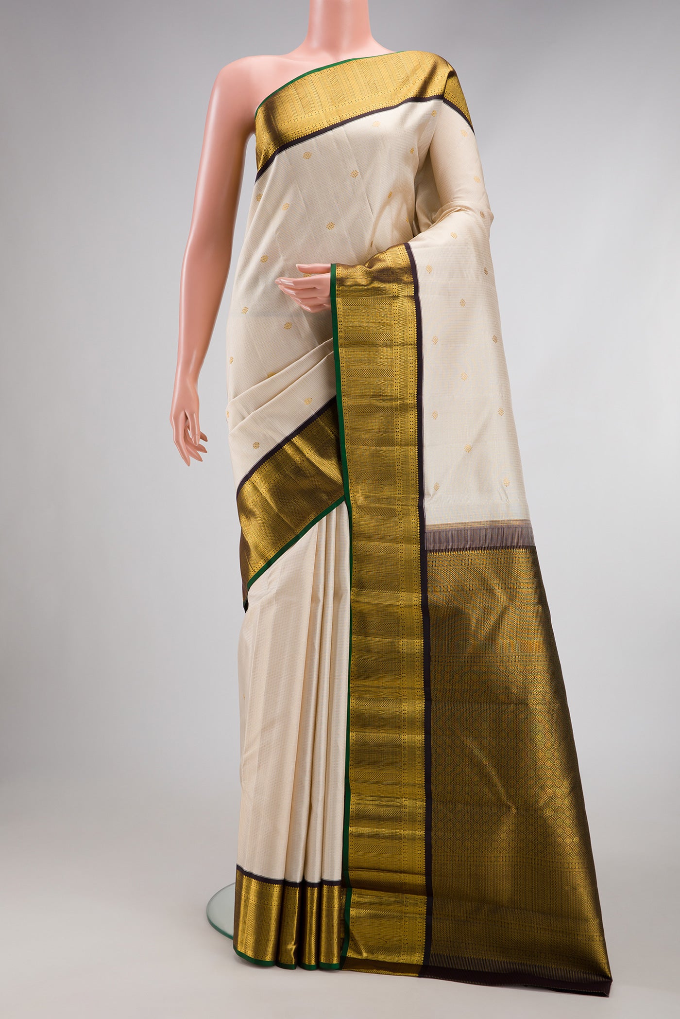 Cream Kanchipuram Silk Saree with Checked design on the body and Zari Border.  displayed on a mannequin