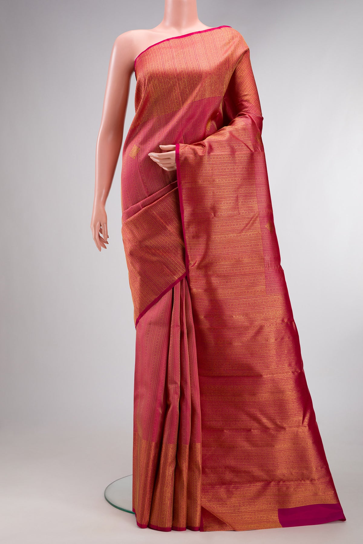 Pure Silk Dark Pink Kanchipuram Saree with Zari Brocade on the body and Zari Border.  displayed on a mannequin