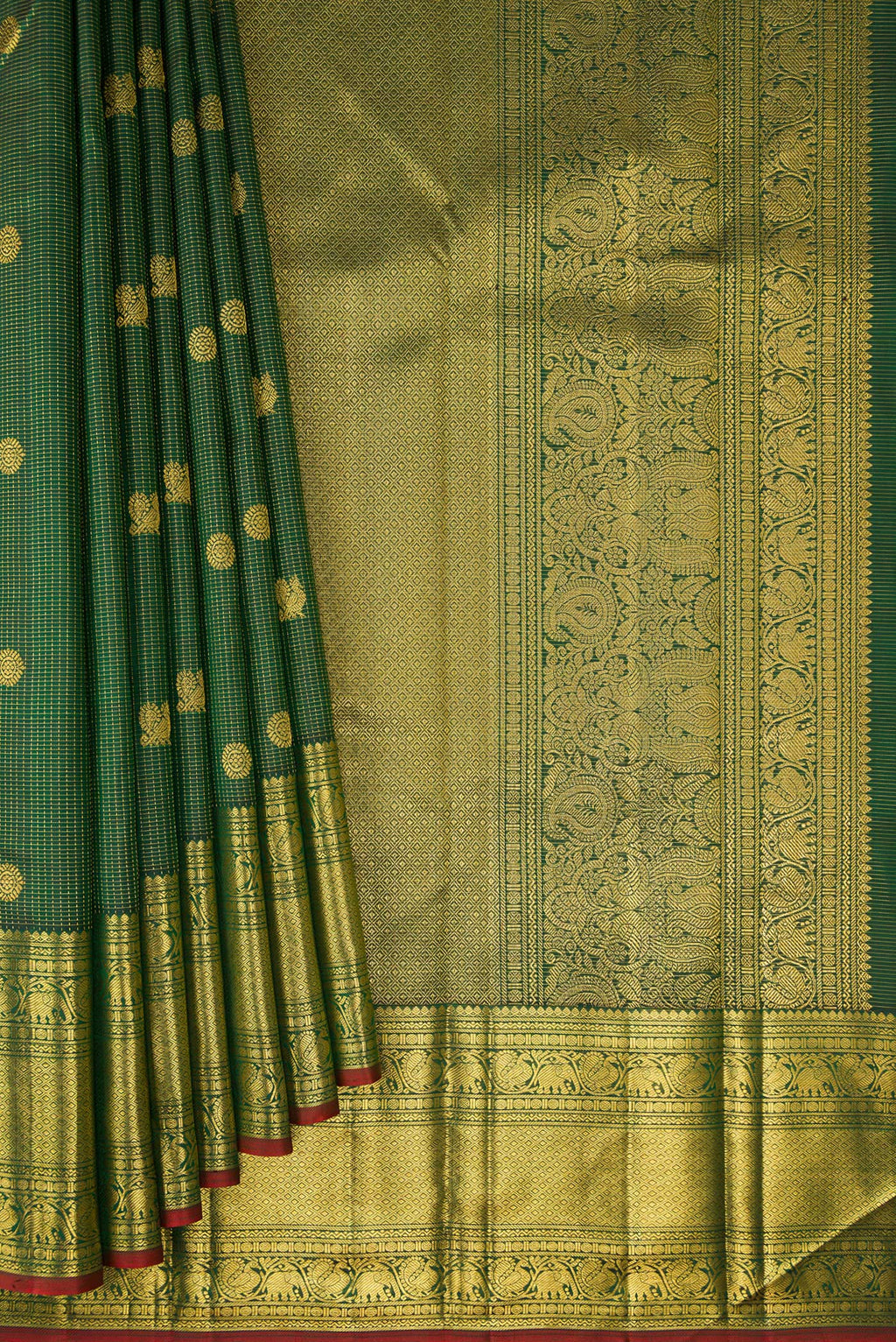 Pleats and pallu of Bottle Green Kanchipuram Silk Saree with Zari Butta on the body and Zari Border. 