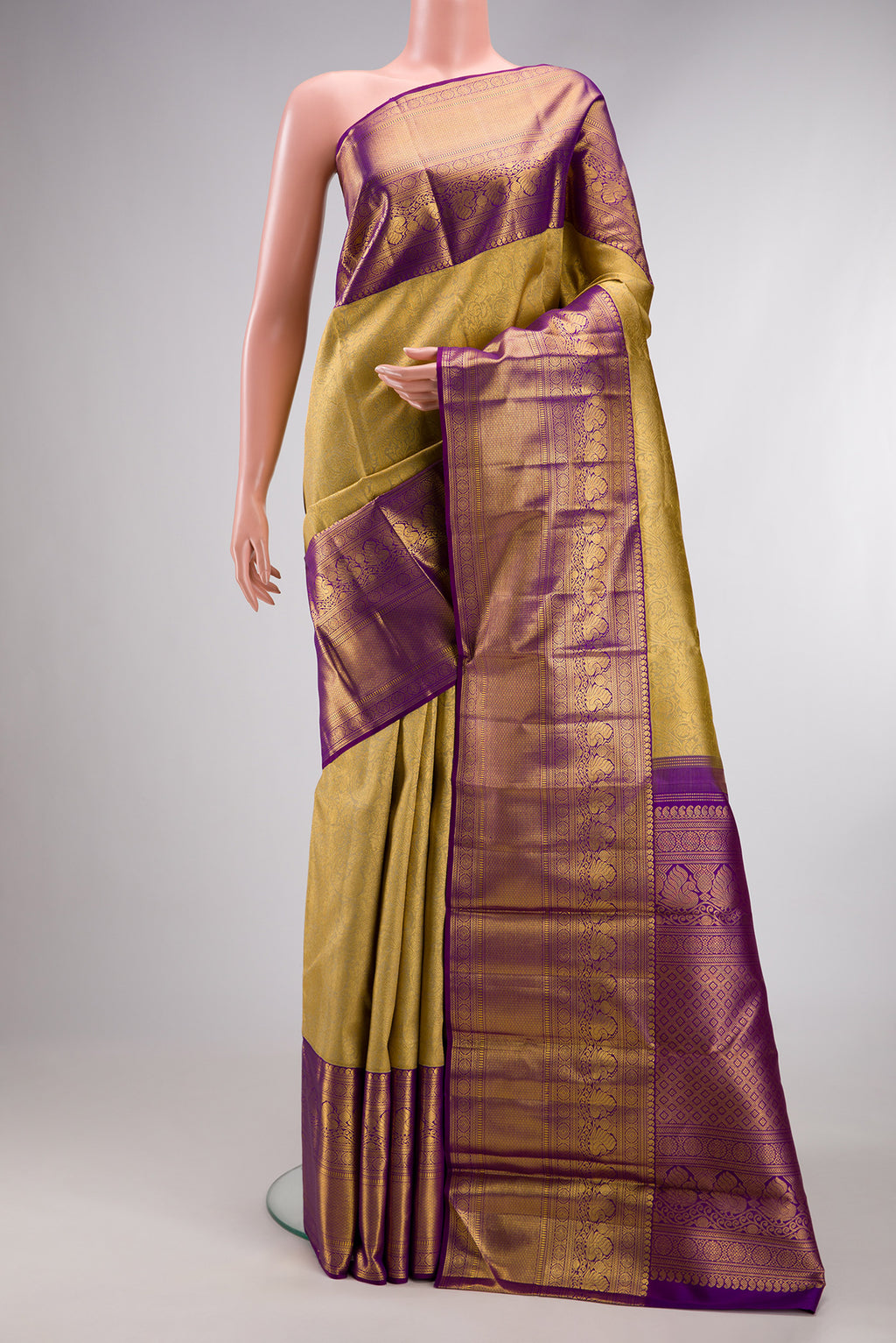 Gold Kanchipuram Silk Saree with Zari Brocade on the body and Zari Border.  displayed on a mannequin