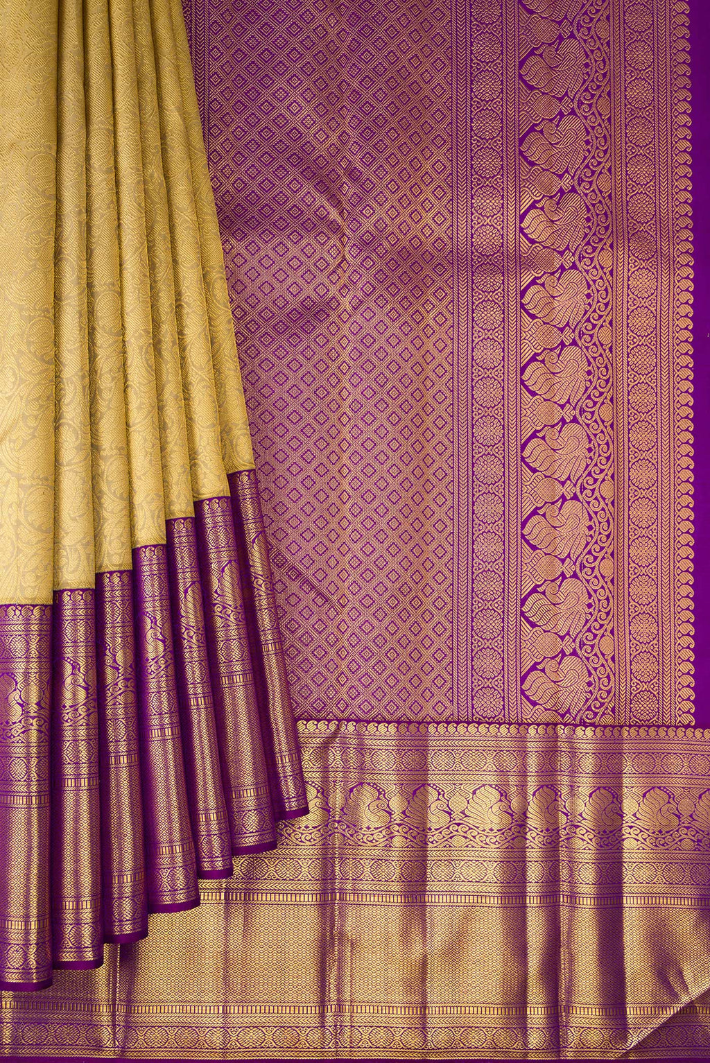 Pleats and pallu of Gold Kanchipuram Silk Saree with Zari Brocade on the body and Zari Border. 