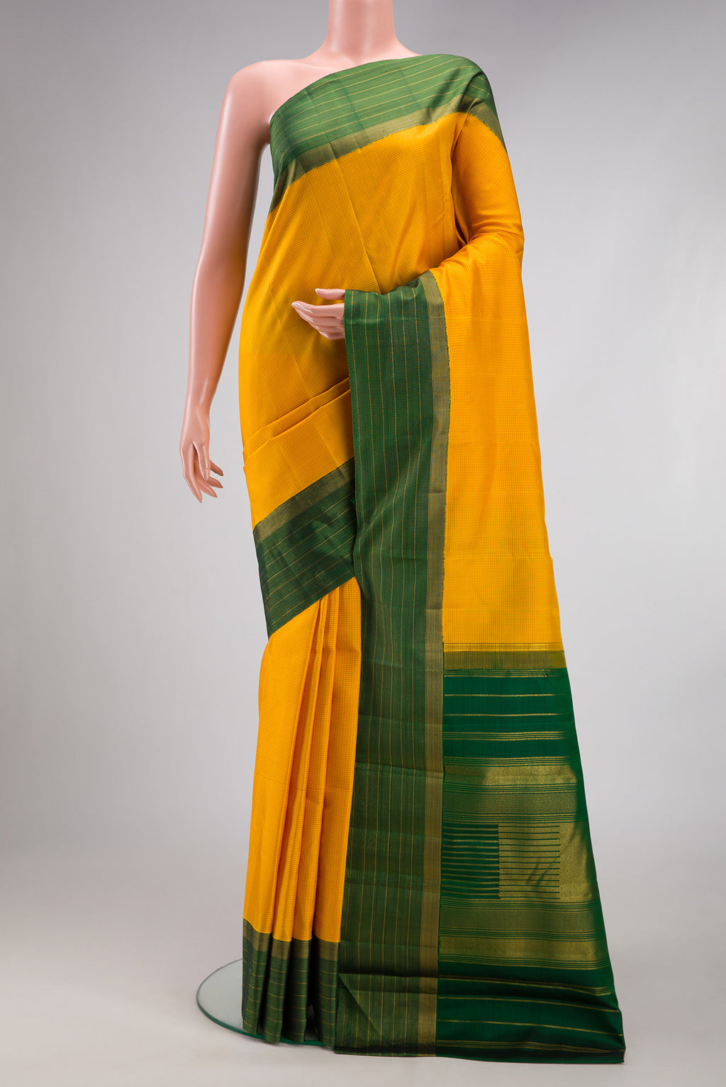 Yellow Kanjivaram Silk Saree with Checked design on the body and Zari Border.  displayed on a mannequin