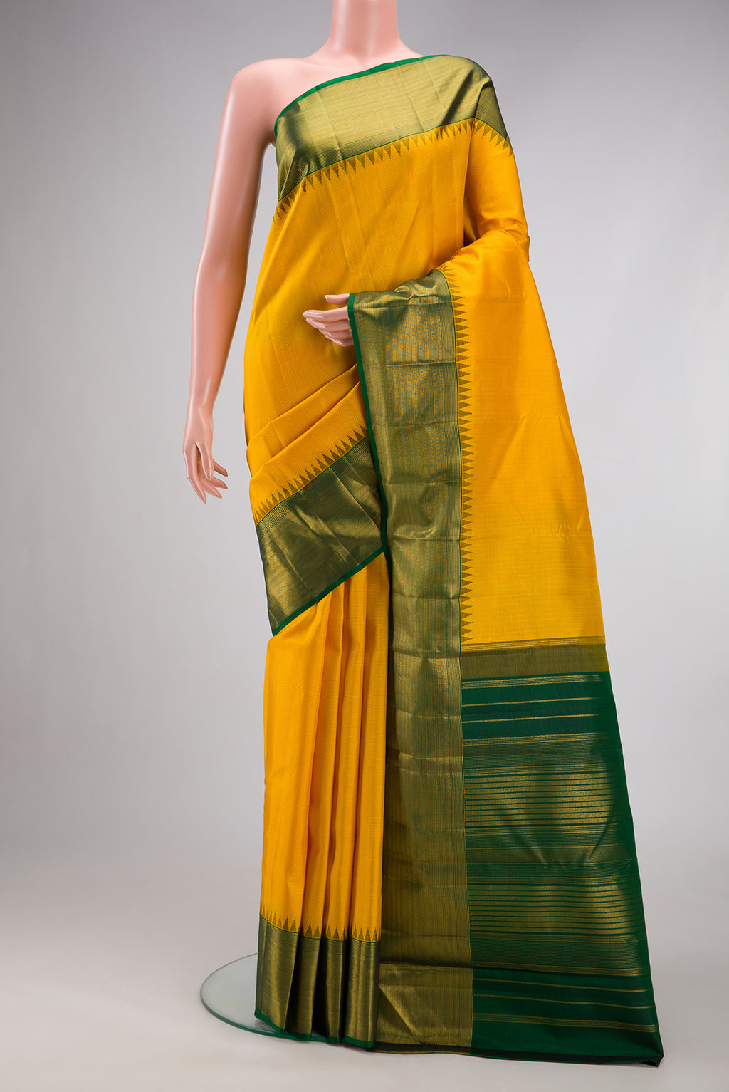 Yellow Kanjivaram Silk Saree with Stripes on the body and Zari Border.  displayed on a mannequin