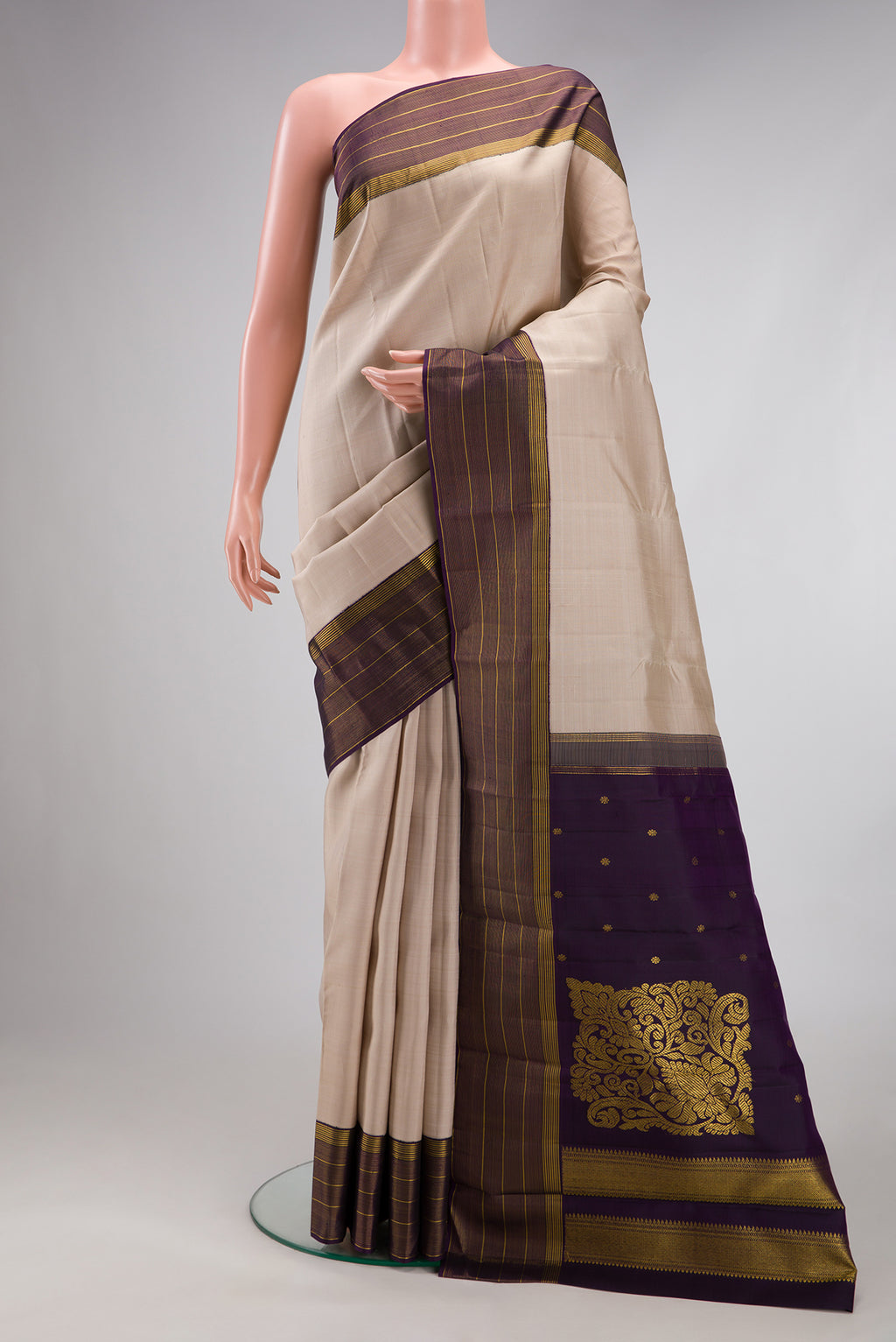 Dark Beige Kanjivaram Silk Saree with Stripes on the body and Zari Border.  displayed on a mannequin