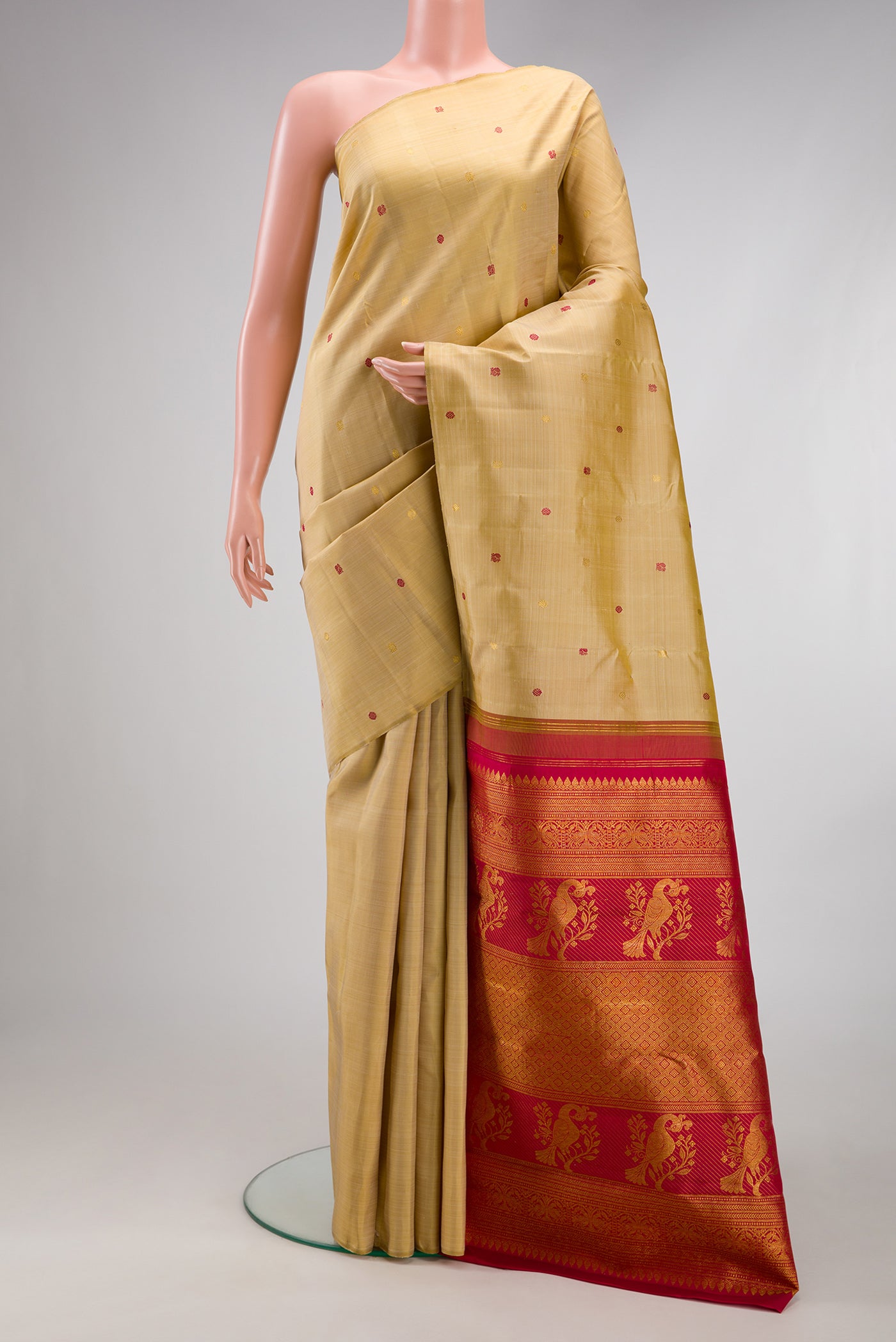 Beige Kanjivaram Silk Saree with Zari And Thread Butta on the body and Without Border.  displayed on a mannequin