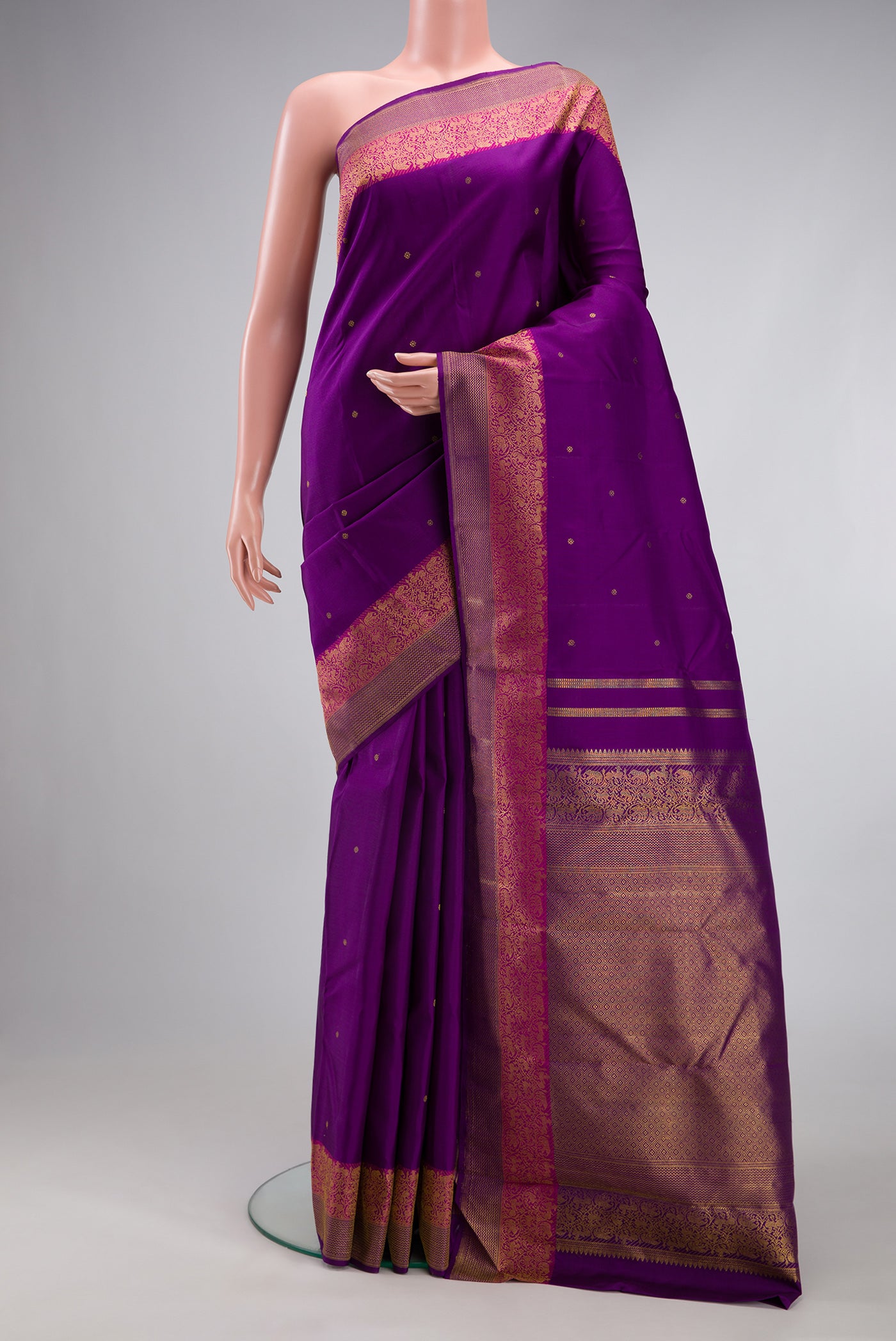 Purple Kanjivaram Silk Saree with Zari Butta on the body and Fancy Border.  displayed on a mannequin