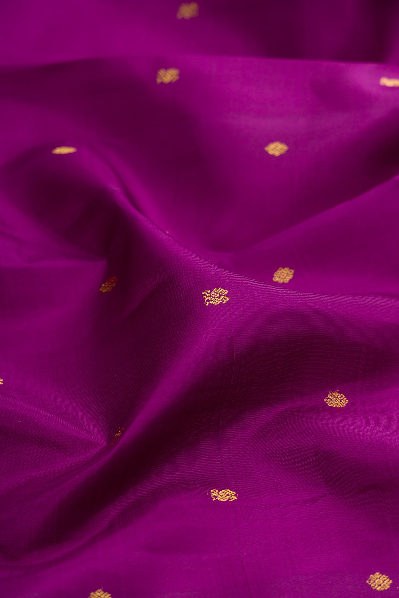 Close up of Purple Kanjivaram Silk Saree with Zari Butta on the body and Zari Border.  displaying folds