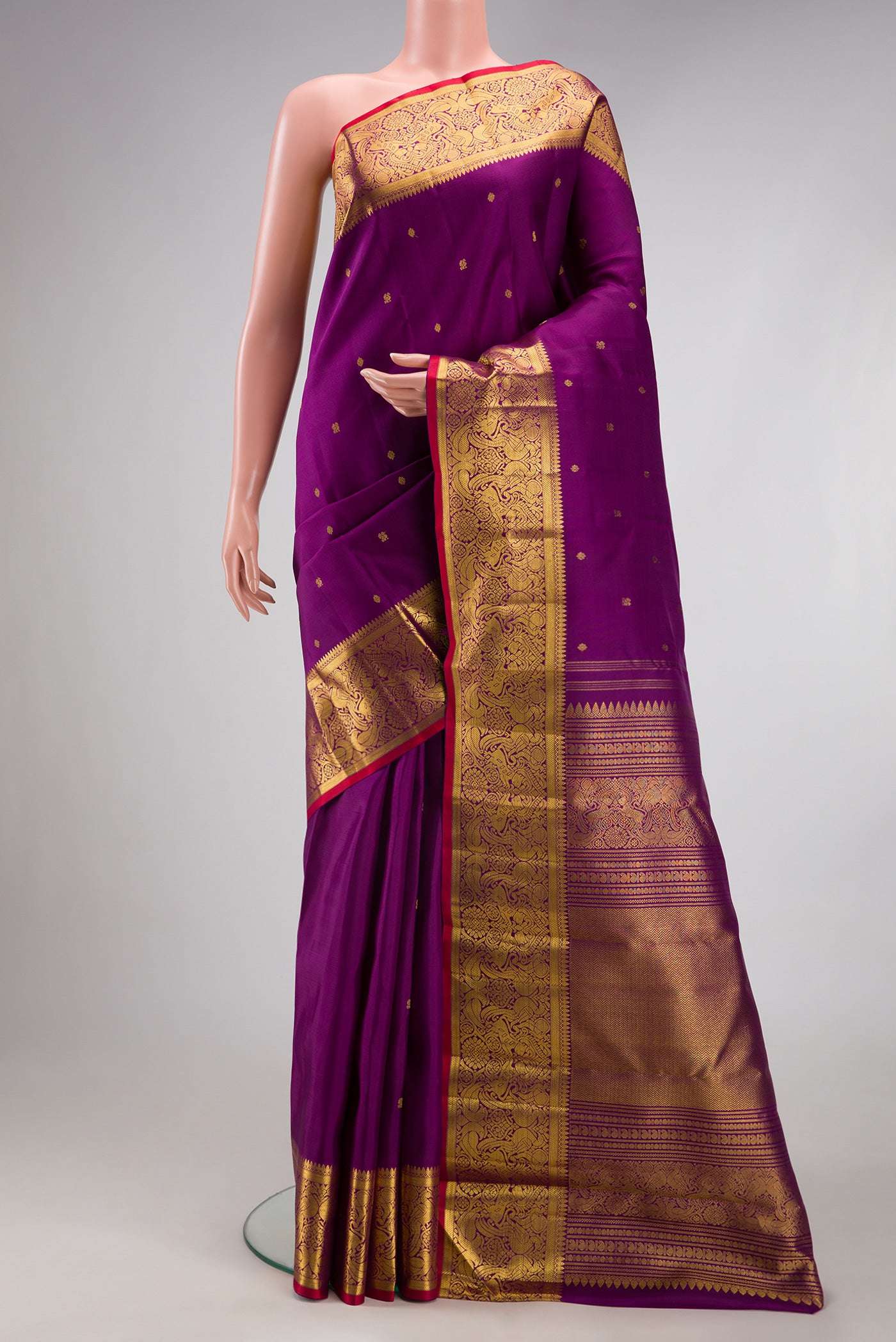 Purple Kanjivaram Silk Saree with Zari Butta on the body and Zari Border.  displayed on a mannequin