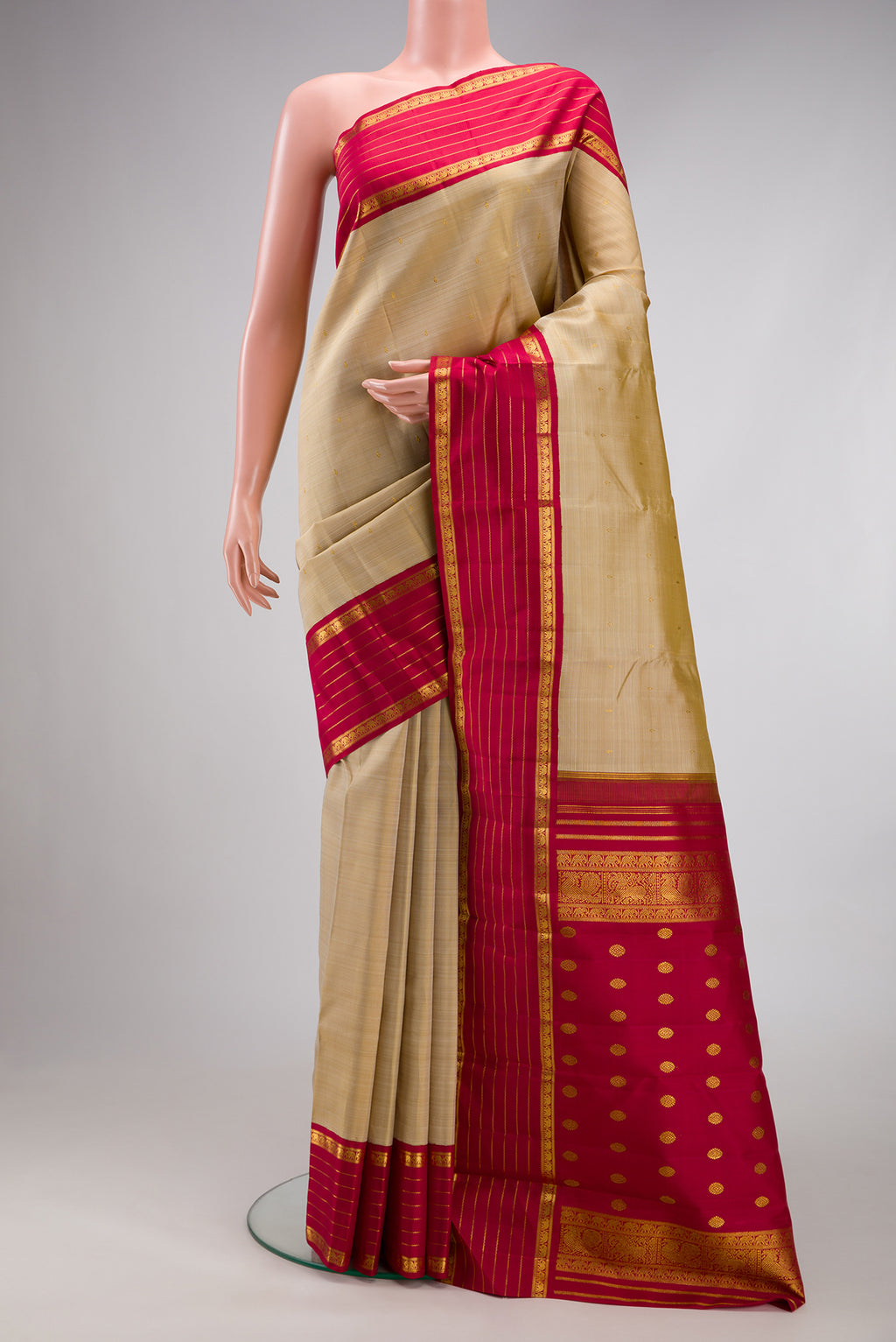 Dark Beige Kanjivaram Silk Saree with Zari Butta on the body and Zari Border.  displayed on a mannequin