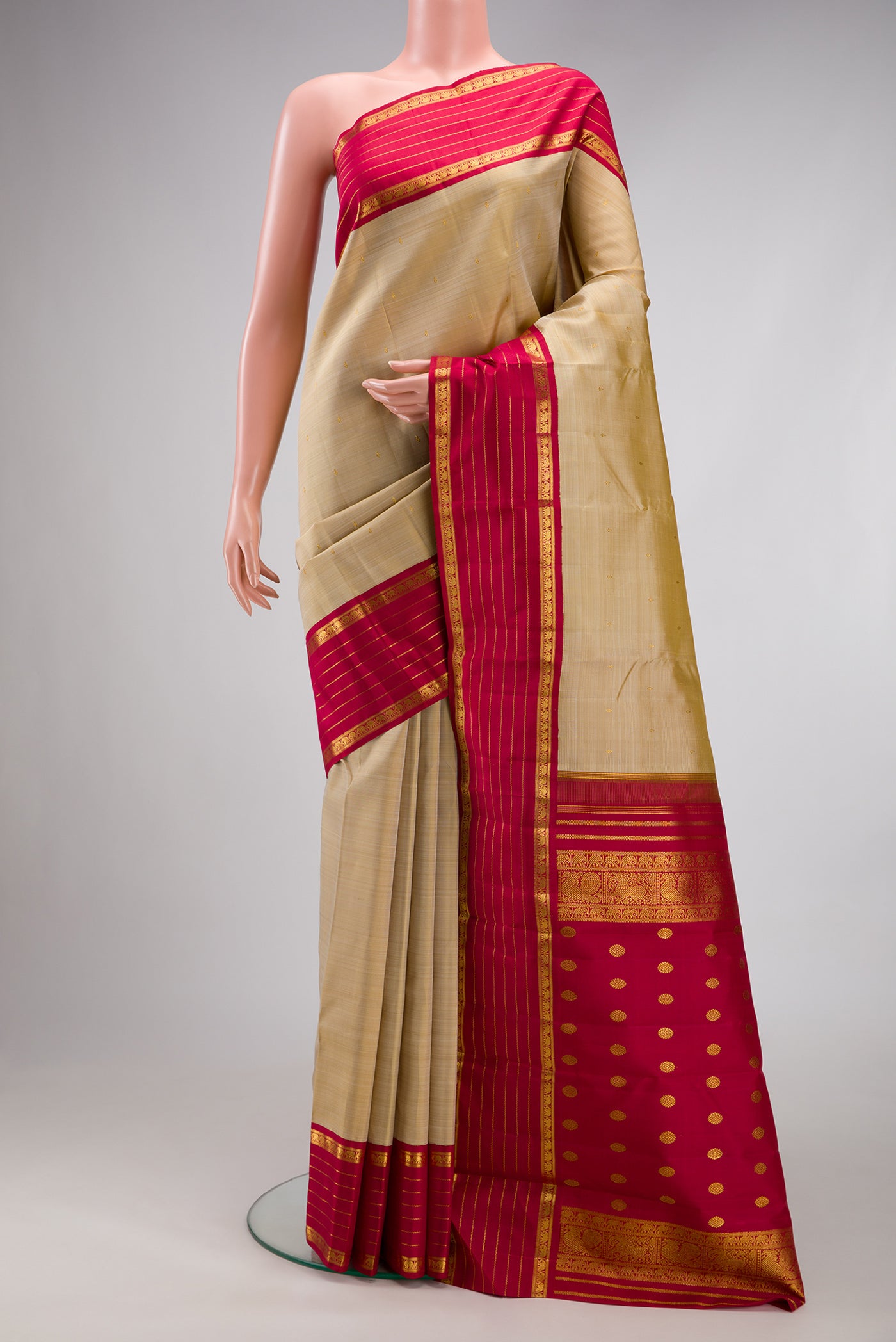 Dark Beige Kanjivaram Silk Saree with Zari Butta on the body and Zari Border.  displayed on a mannequin