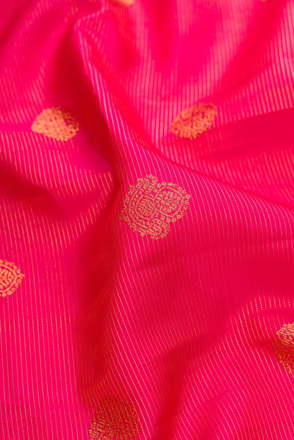 Close up of Pure Silk Dark Pink Kanchipuram Saree with Stripes on the body and Fancy Border.  displaying folds
