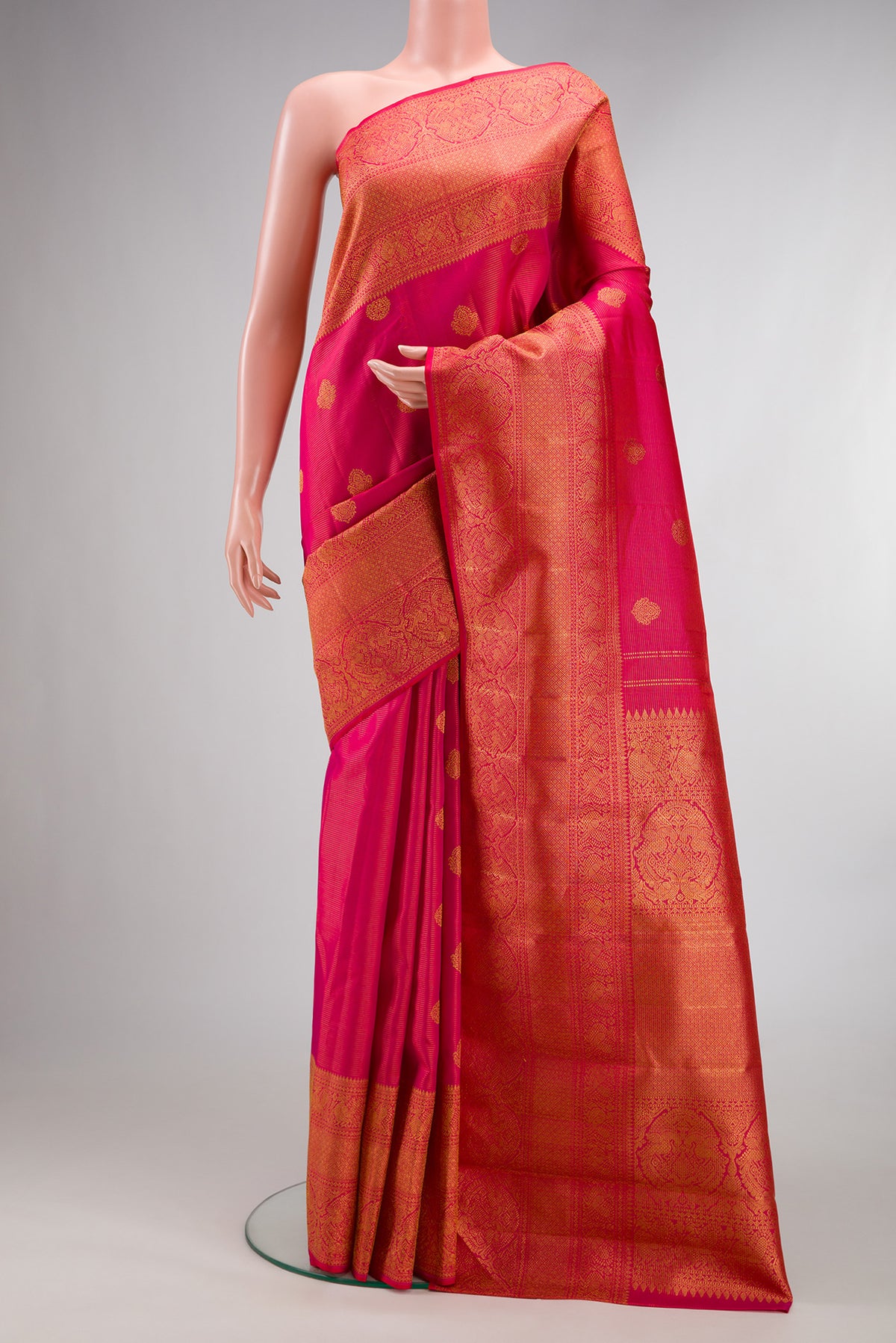 Pure Silk Dark Pink Kanchipuram Saree with Stripes on the body and Fancy Border.  displayed on a mannequin