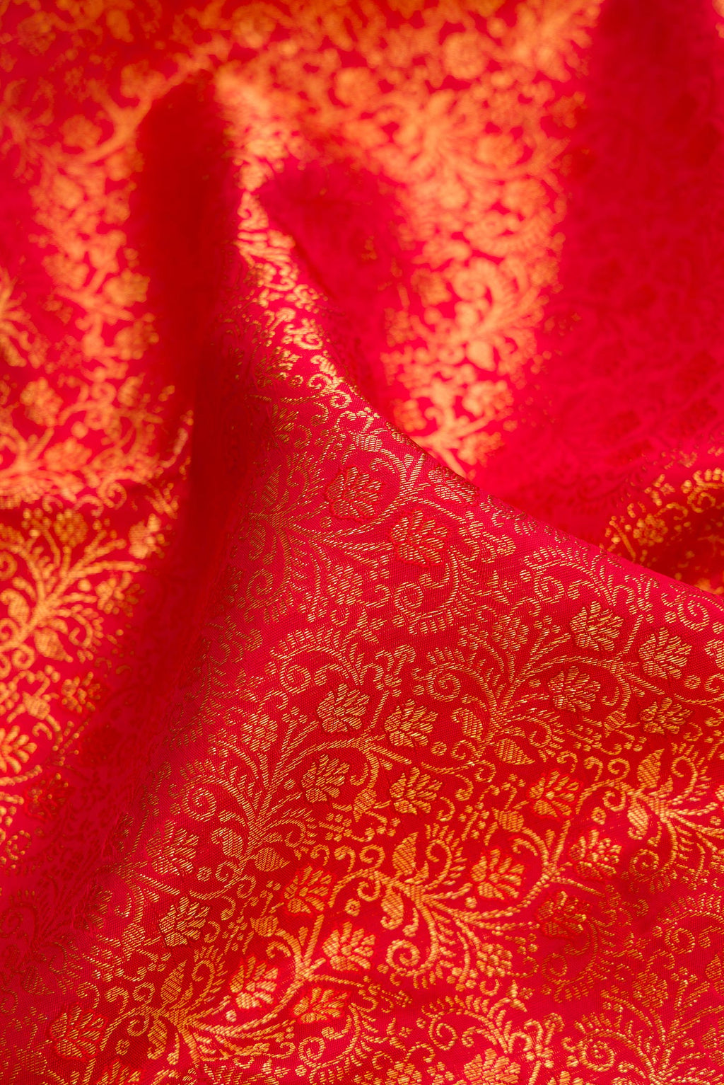 Close up of Pure Silk Red Dual Tone Kanchipuram Saree with Zari Brocade on the body and Fancy Border.  displaying folds