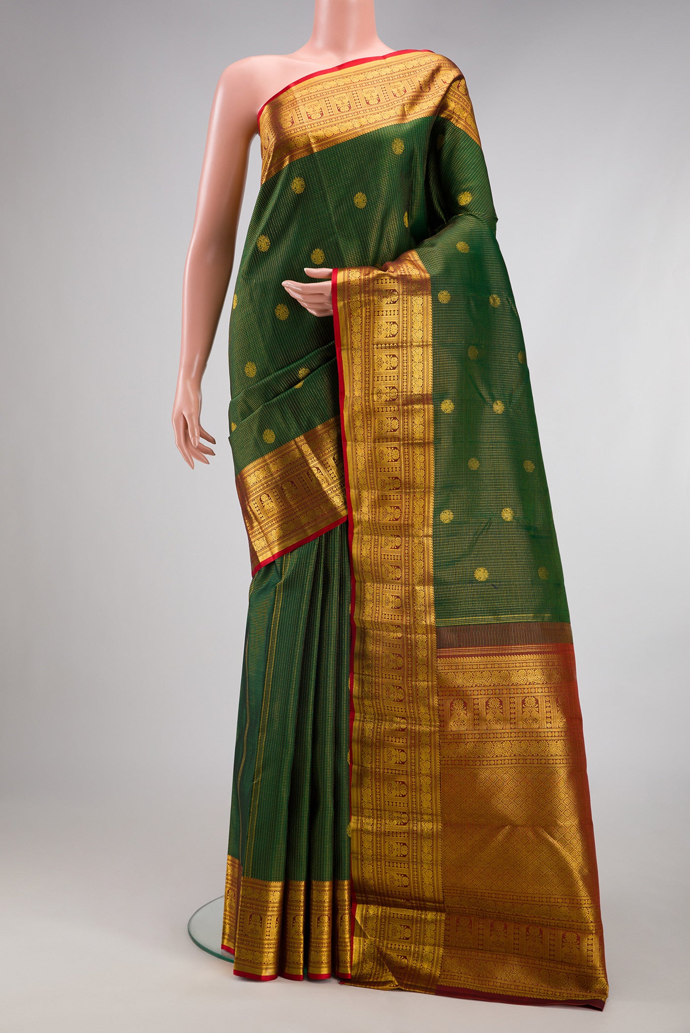 Bottle Green Kanchipuram Silk Saree with Checked design on the body and Fancy Border.  displayed on a mannequin
