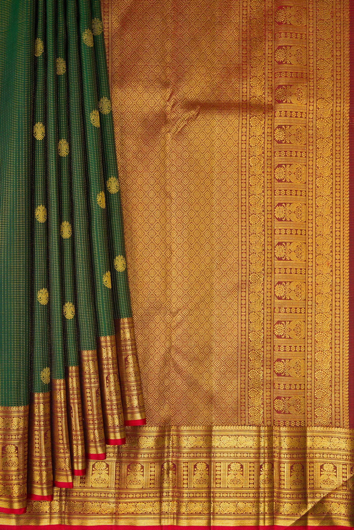 Pleats and pallu of Bottle Green Kanchipuram Silk Saree with Checked design on the body and Fancy Border. 