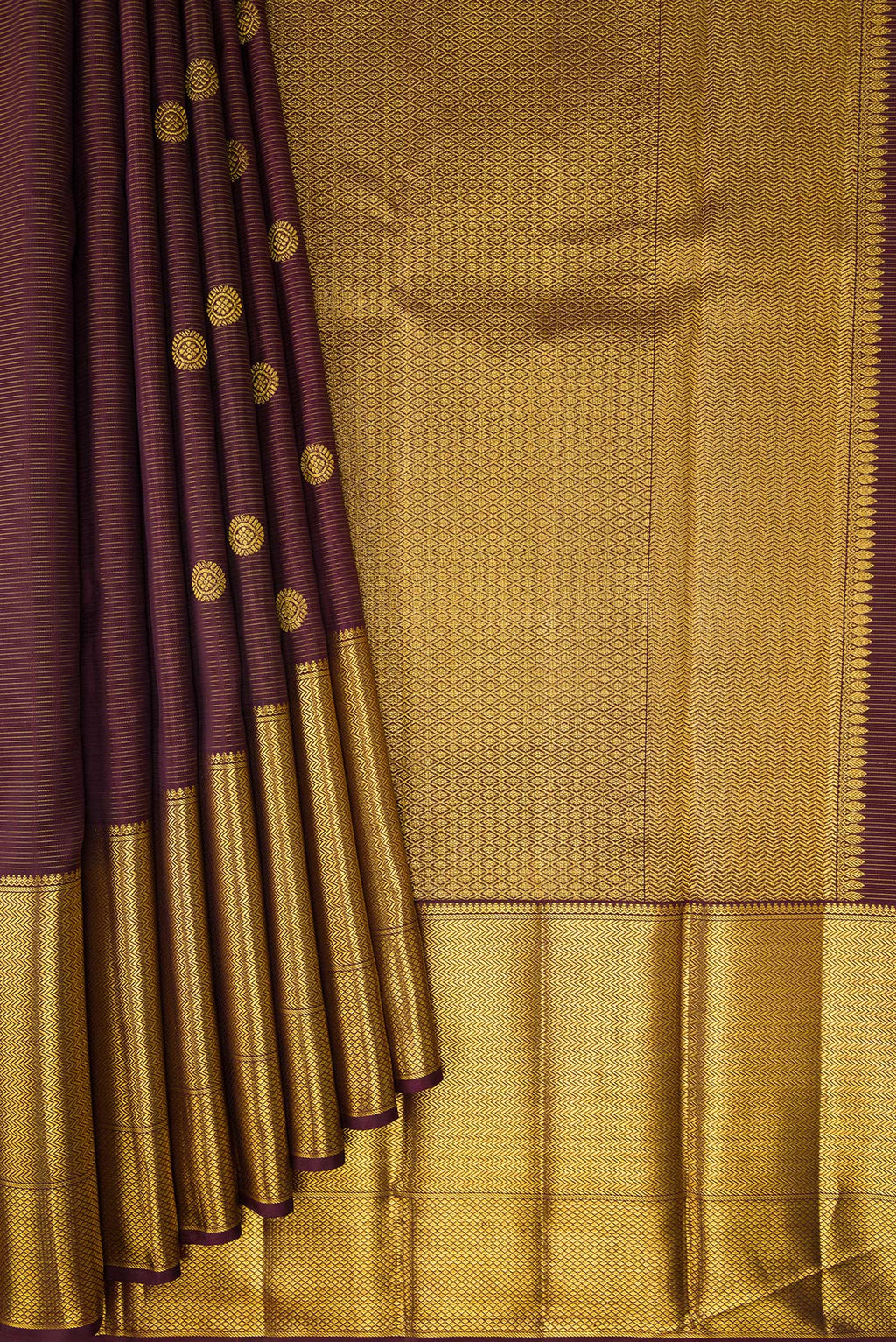 Pleats and pallu of Brown Kanchipuram Silk Saree with Zari Butta on the body and Zari Border. 