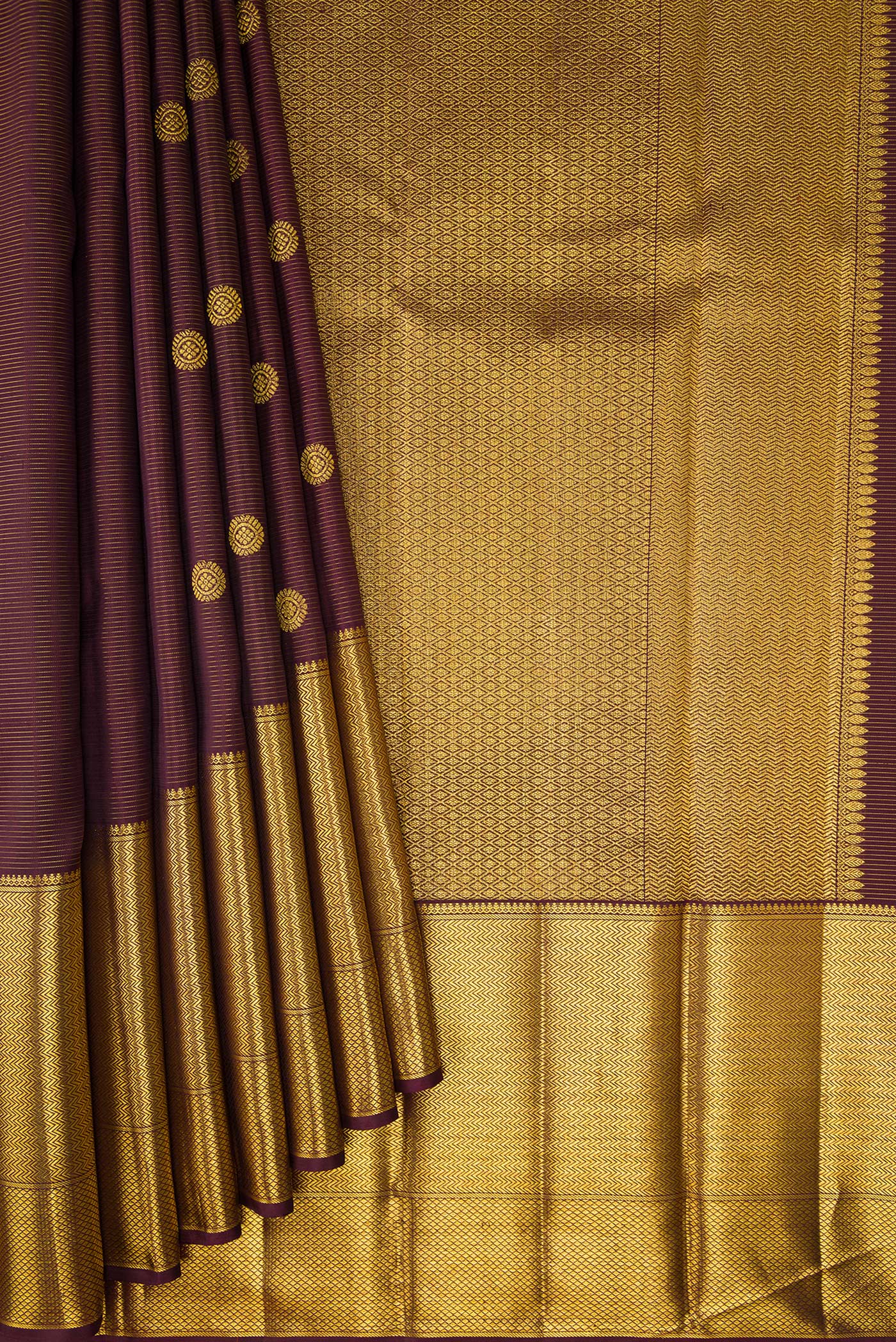 Pleats and pallu of Brown Kanchipuram Silk Saree with Zari Butta on the body and Zari Border. 