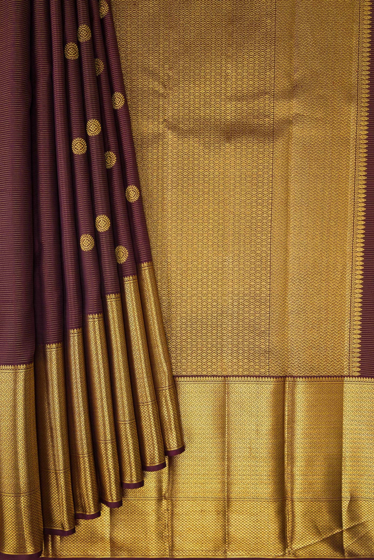Pleats and pallu of Brown Kanchipuram Silk Saree with Zari Butta on the body and Zari Border. 