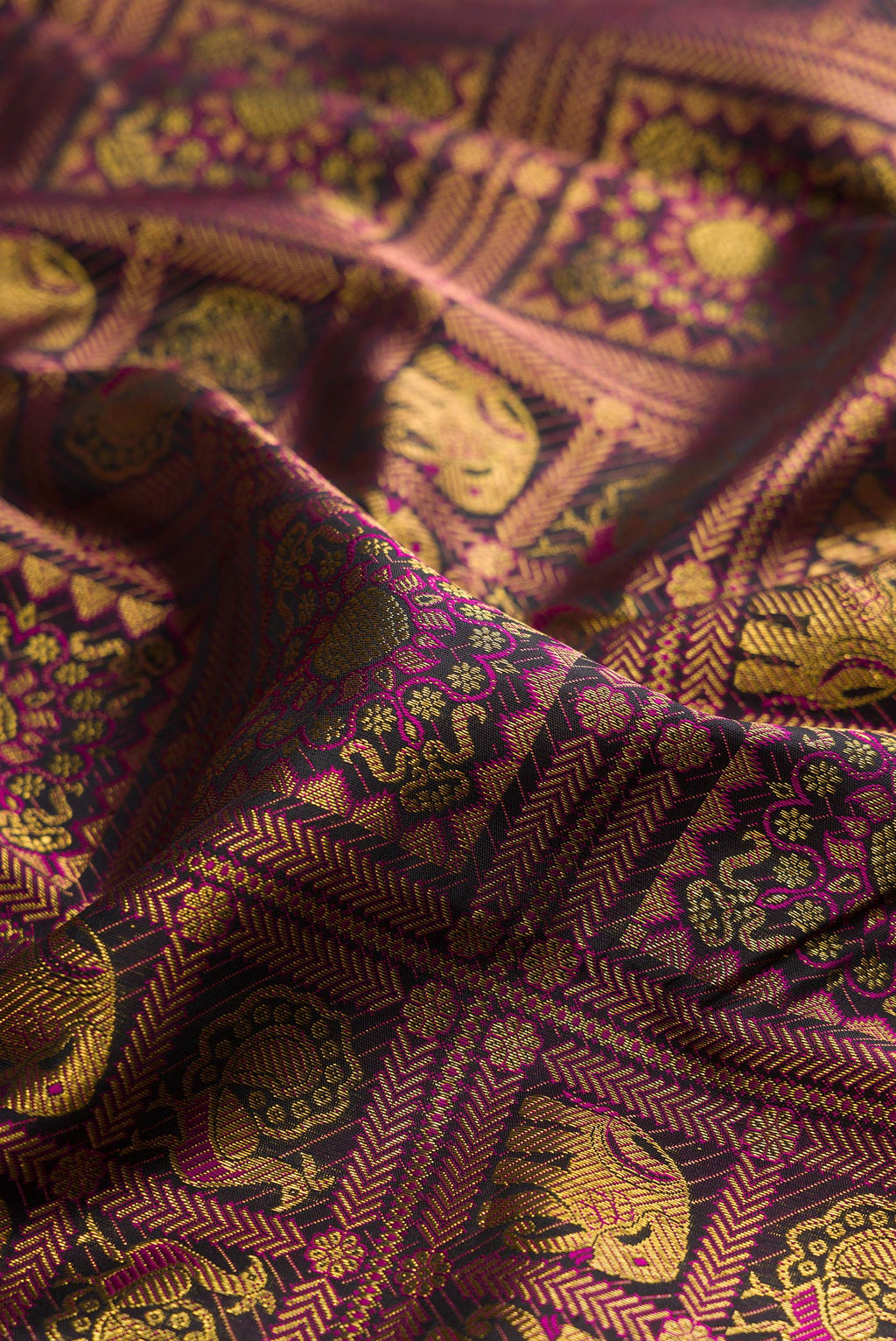 Close up of Pure Silk Black Kanchipuram Saree with Zari Brocade on the body and Plain Border.  displaying folds