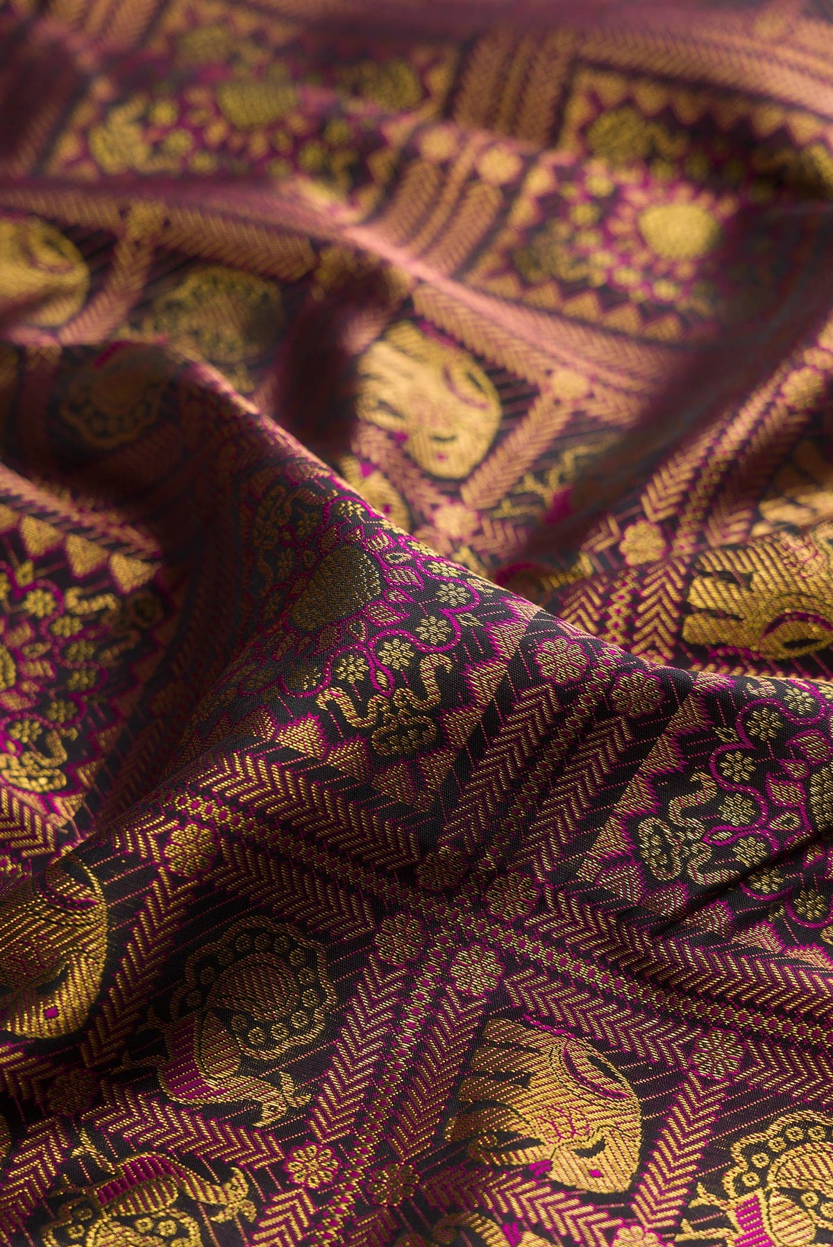 Close up of Pure Silk Black Kanchipuram Saree with Zari Brocade on the body and Plain Border.  displaying folds