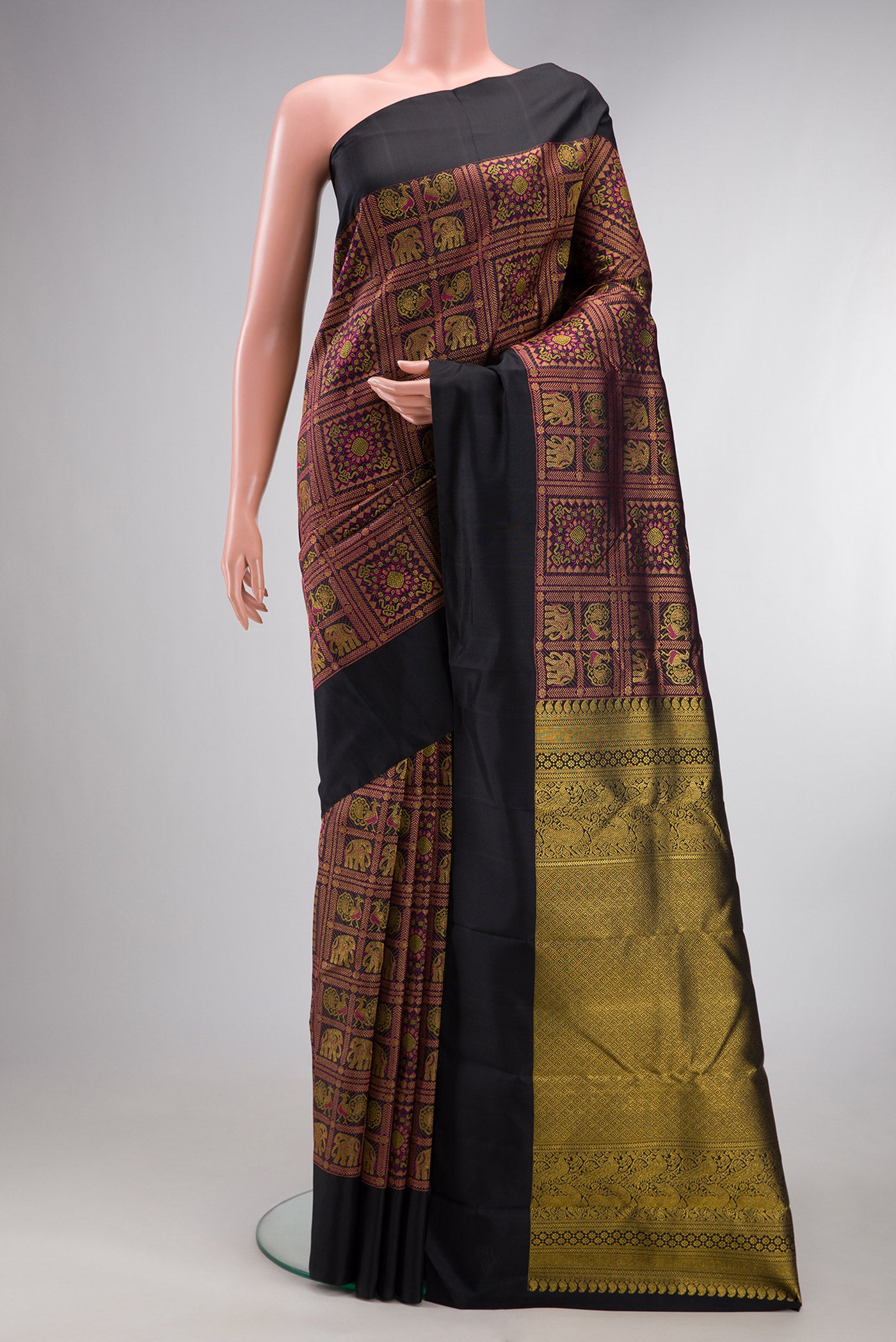 Pure Silk Black Kanchipuram Saree with Zari Brocade on the body and Plain Border.  displayed on a mannequin