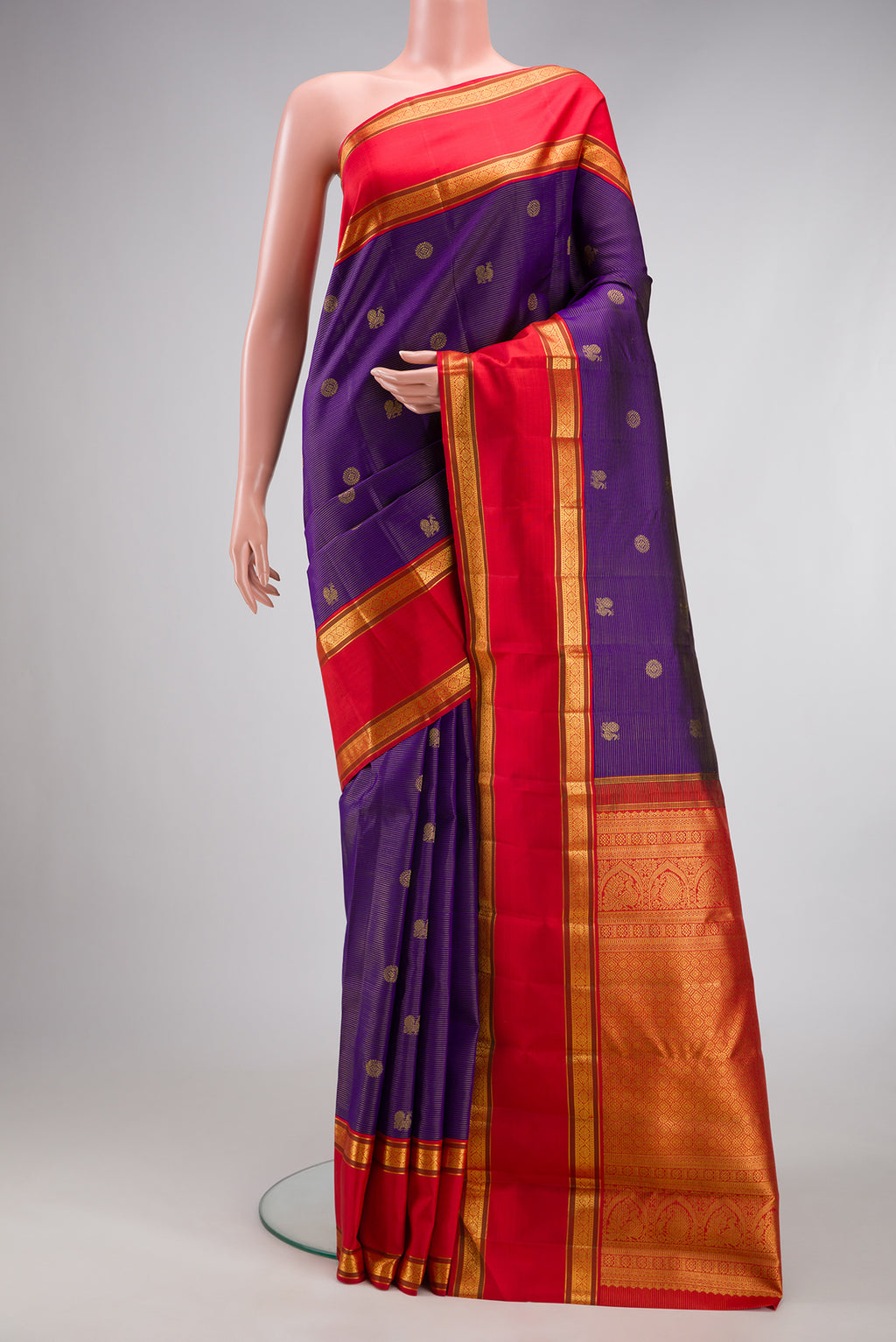 Navy Blue Dual Tone Kanchipuram Silk Saree with Stripes on the body and Fancy Border.  displayed on a mannequin
