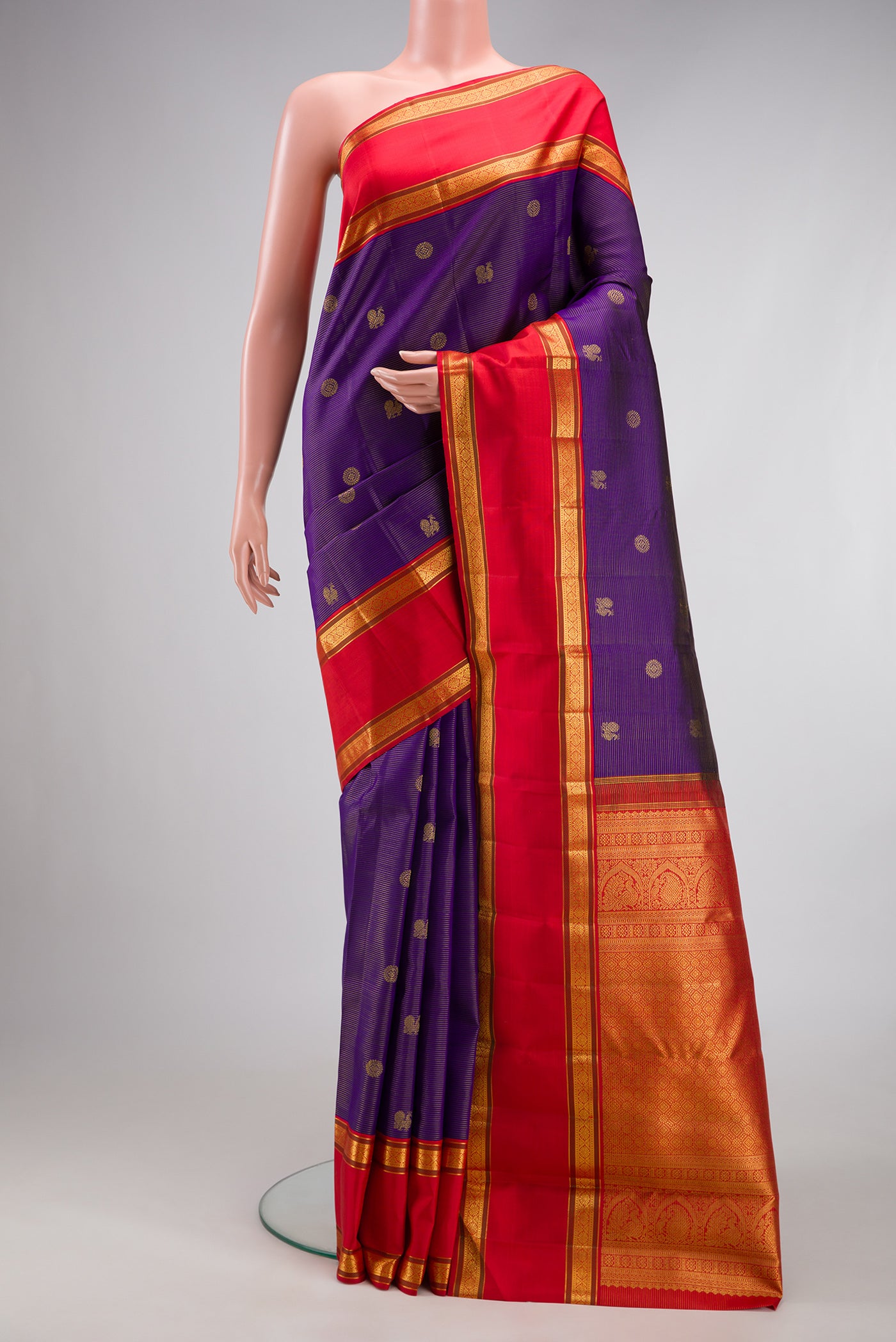 Navy Blue Dual Tone Kanchipuram Silk Saree with Stripes on the body and Fancy Border.  displayed on a mannequin