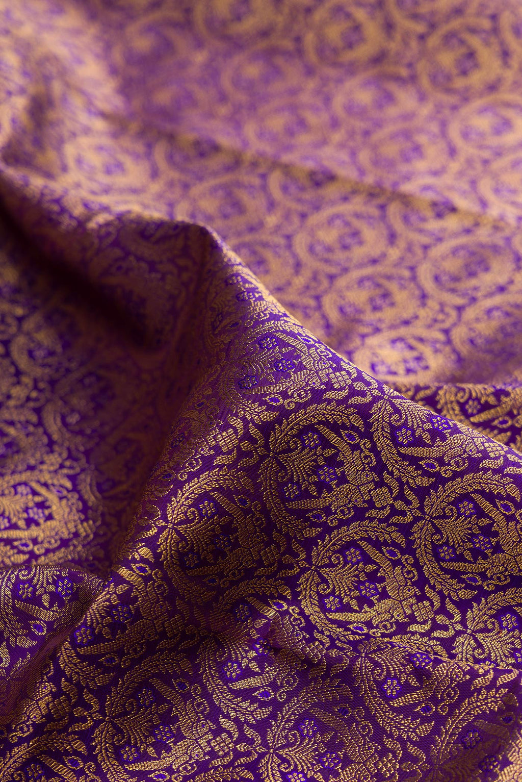 Close up of Pure Silk Violet Kanchipuram Saree with Zari Brocade on the body and Zari Border.  displaying folds