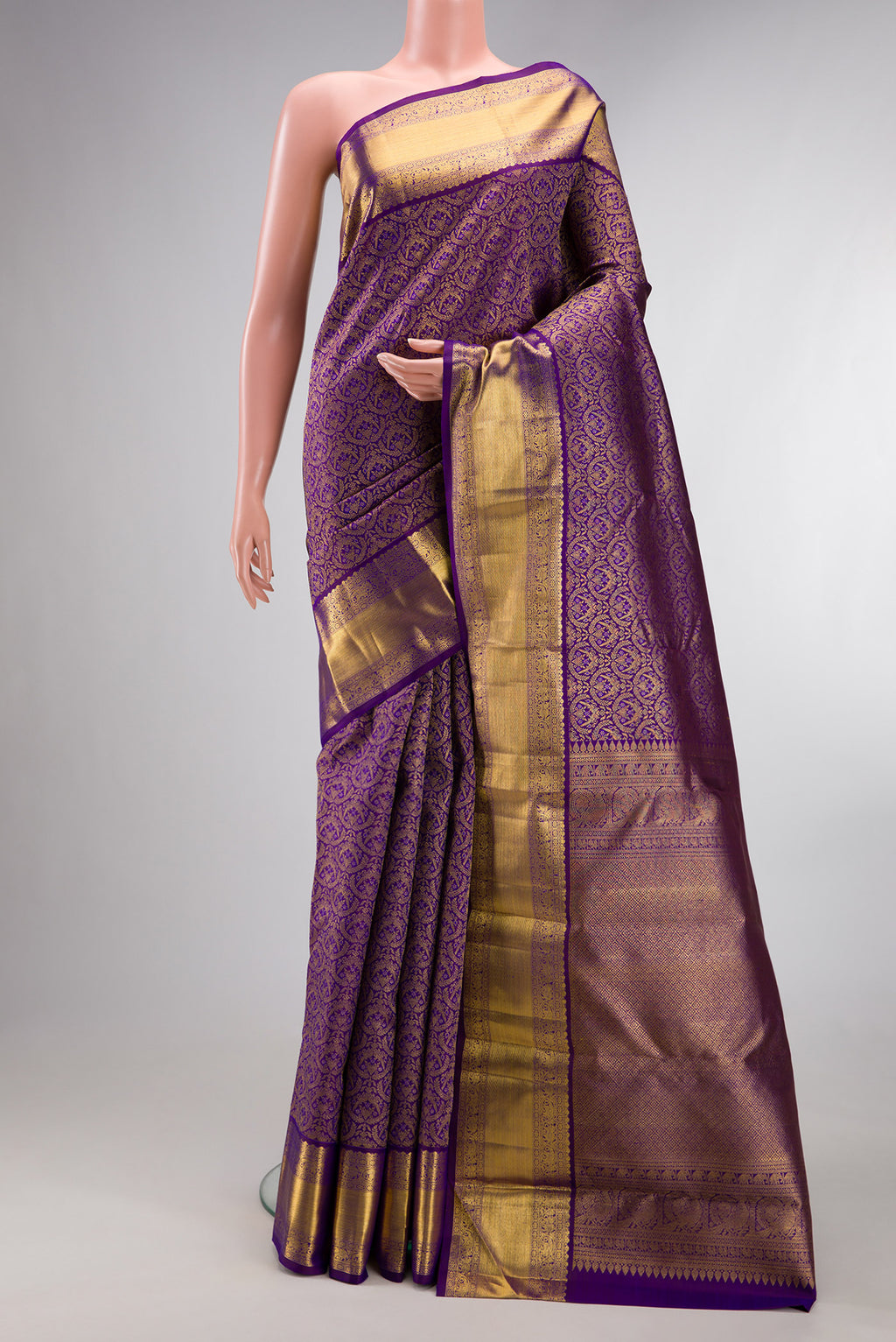 Pure Silk Violet Kanchipuram Saree with Zari Brocade on the body and Zari Border.  displayed on a mannequin