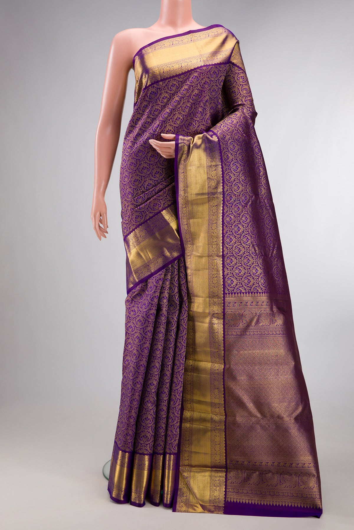 Pure Silk Violet Kanchipuram Saree with Zari Brocade on the body and Zari Border.  displayed on a mannequin