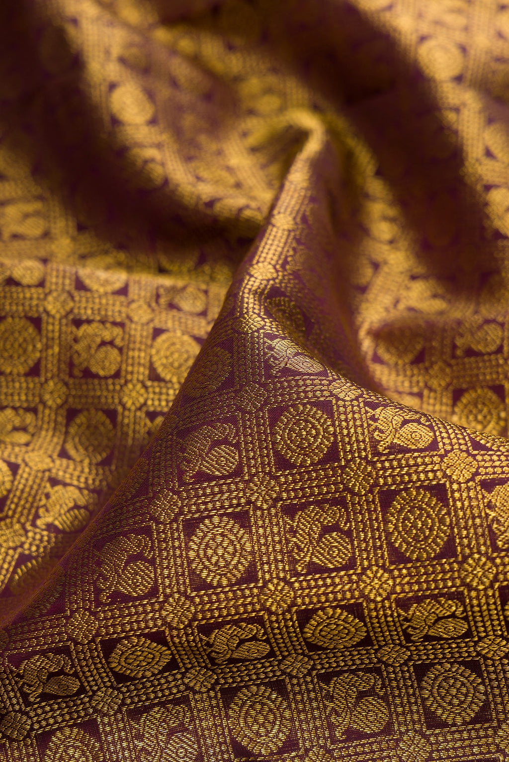 Close up of Pure Silk Coffee Brown Kanchipuram Saree with Zari Brocade on the body and Zari Border.  displaying folds
