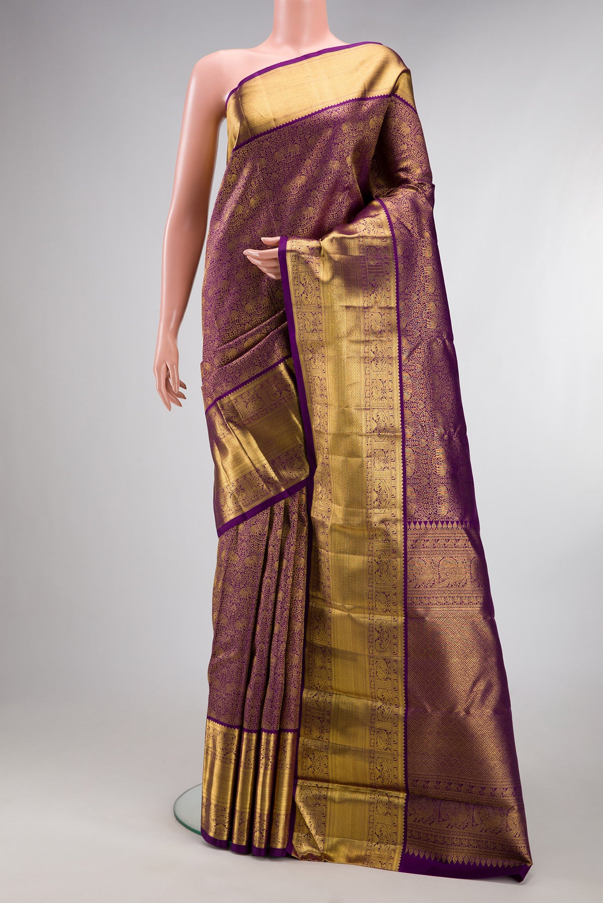 Pure Silk Purple Kanchipuram Saree with Zari Brocade on the body and Zari Border.  displayed on a mannequin