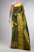 Pure Silk Bottle Green Kanchipuram Saree with Zari Brocade on the body and Zari Border.  displayed on a mannequin