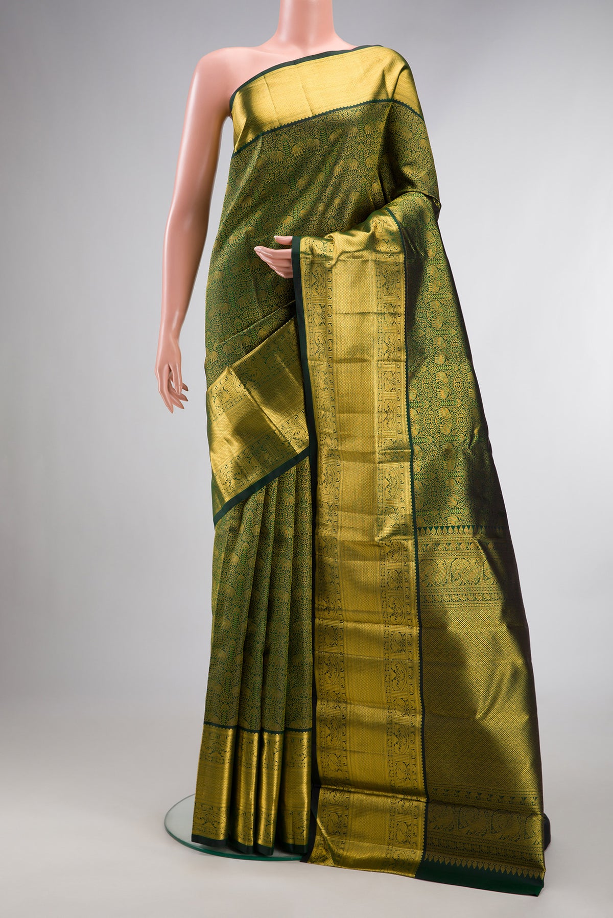 Pure Silk Bottle Green Kanchipuram Saree with Zari Brocade on the body and Zari Border.  displayed on a mannequin