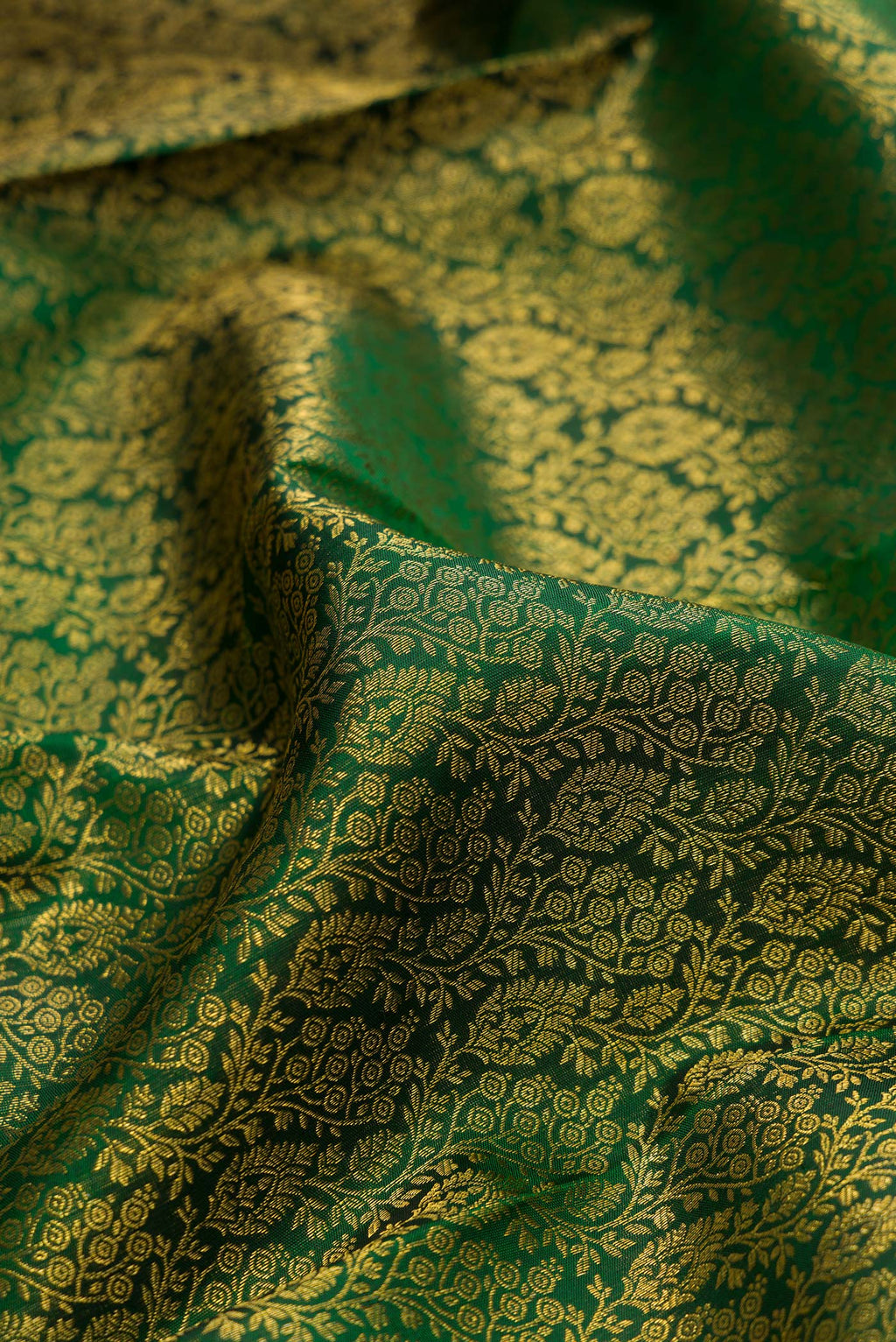Close up of Pure Silk Green Kanjivaram Saree with Zari Brocade on the body and Zari Border.  displaying folds