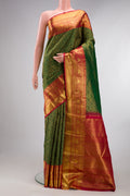 Pure Silk Green Kanjivaram Saree with Zari Brocade on the body and Zari Border.  displayed on a mannequin