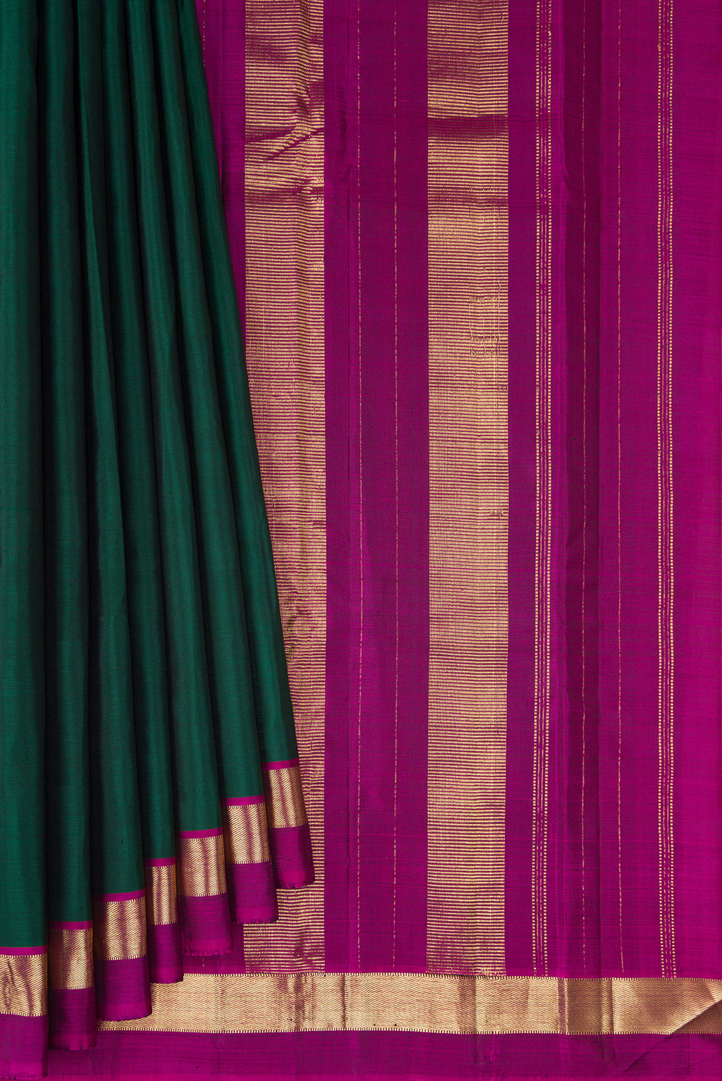 Pleats and pallu of Bottle Green Kanjivaram Silk Saree with Plain Body and Zari Border. 