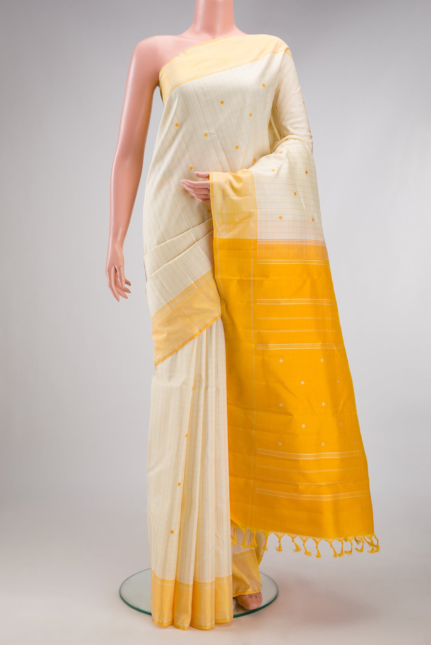 Sandal Kanjivaram Silk Saree with Checked design on the body and Thread Border.  displayed on a mannequin