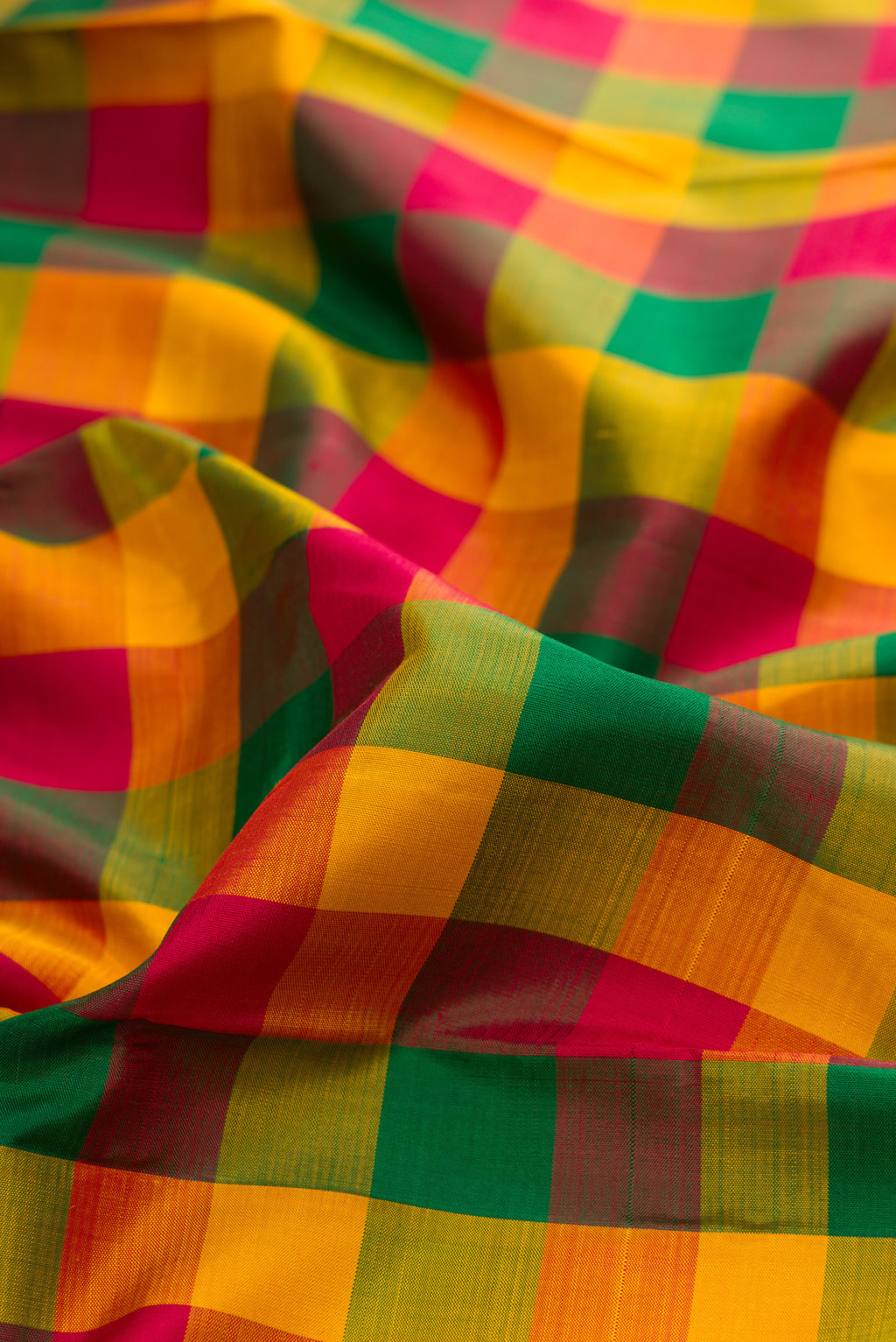Close up of Multi Color Kanjivaram Silk Saree with Checked design on the body and Without Border.  displaying folds
